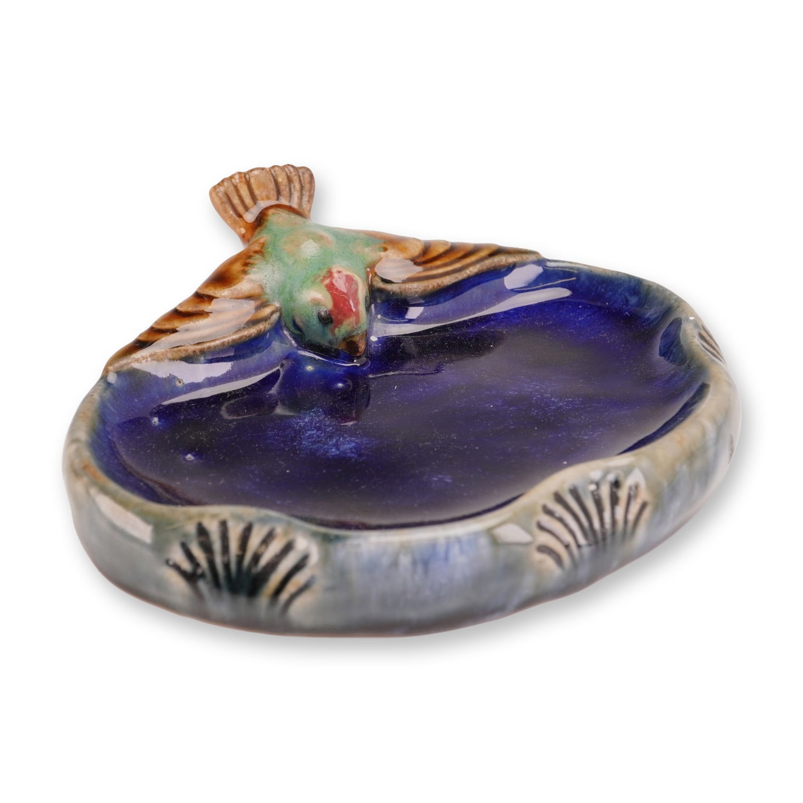 Doulton Lambeth by Harry Simeon Stoneware Bibelot, Bird with Outstretched Wings: Royal Doulton Lambeth figural stoneware dish featuring a bird perched on the rim in a drinking posture. The shallow, oval-form vessel is finished with a deep cobalt blue glaze to the interior and reli