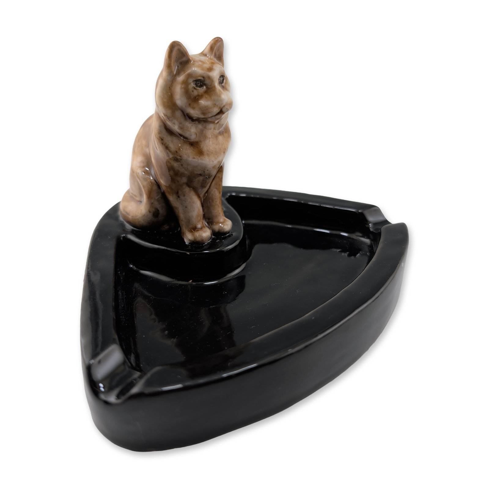 Doulton Lambeth Stoneware Very Rare Cat Bibelot: The triangular ceramic base is finished in a high-gloss black glaze and features two cigarette rests. A stylized seated cat figure is mounted at one corner, decorated in a mottled tan and brown glaze.