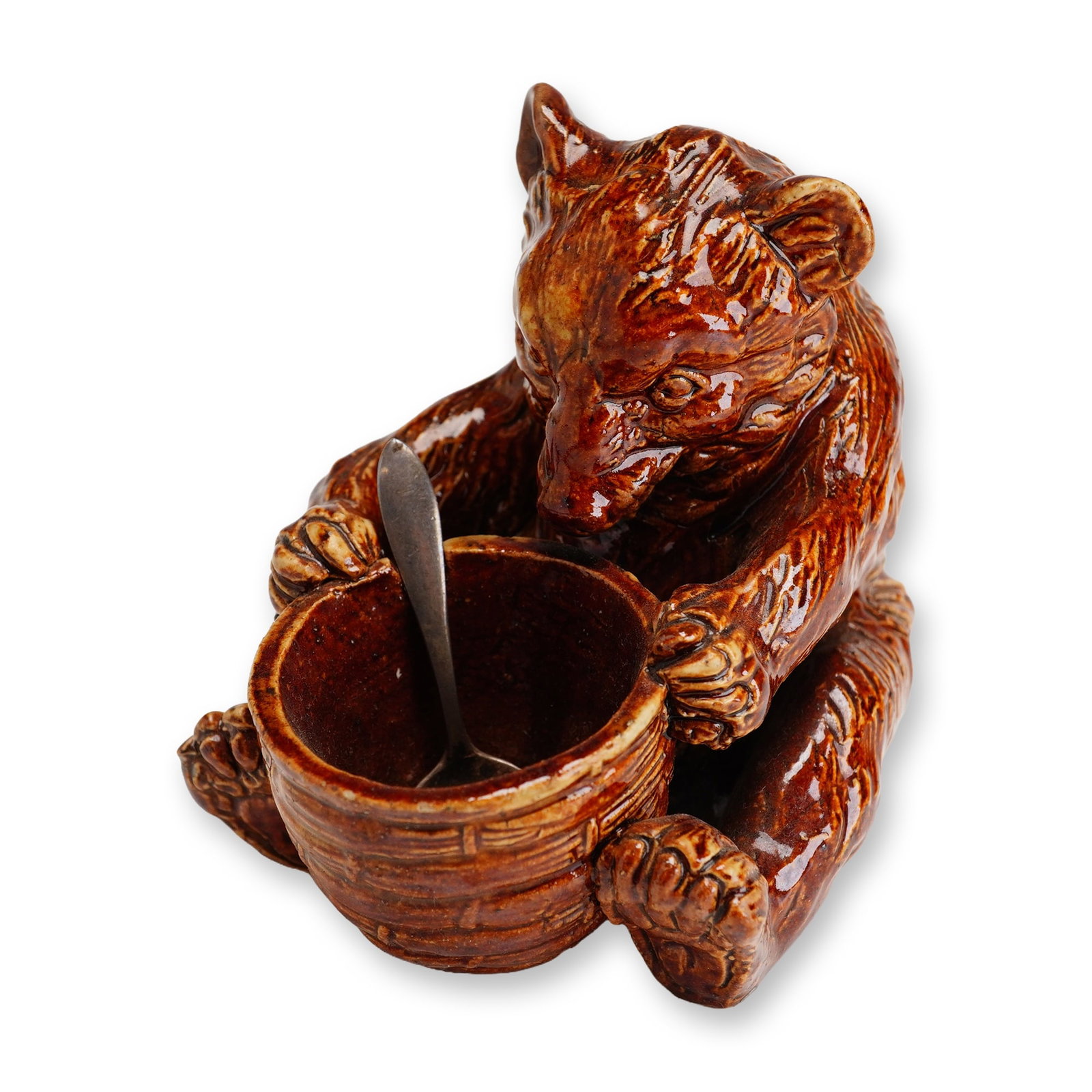 Doulton Lambeth Stoneware with Sterling Silver Spoon, Bear with Honey Pot: A brown bear is depicted examining a honey pot, which doubles as a serving vessel for dry condiments. The set includes a plain sterling silver handled spoon. Royal Lambeth impressed mark present, with