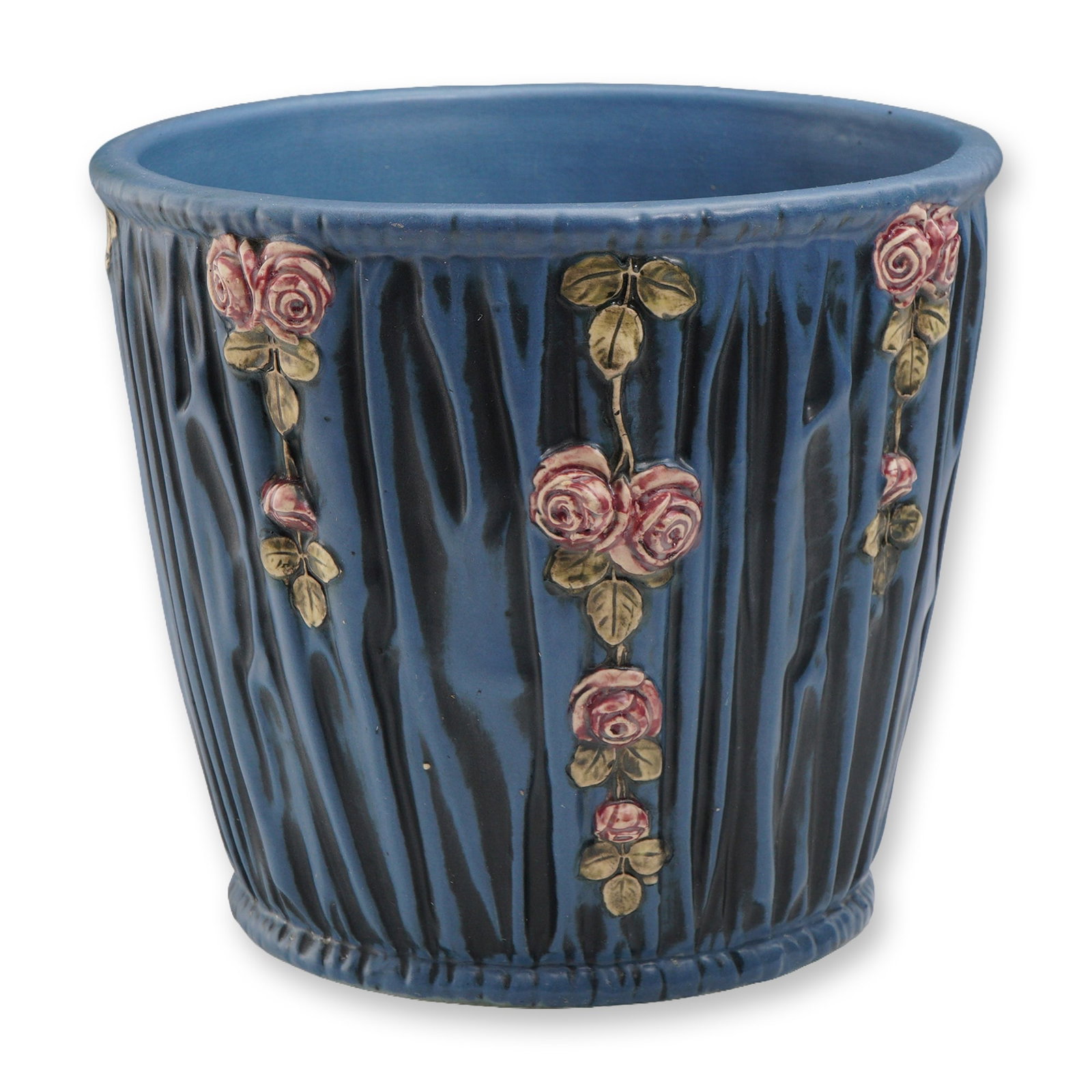 Weller Pottery Blue Drape Jardiniere: A Weller Pottery jardiniere in the Blue Drape pattern. This example features a rich cobalt-blue ground with vertical drapery ribbing and applied garlands of pink roses with green leaves in relief. The