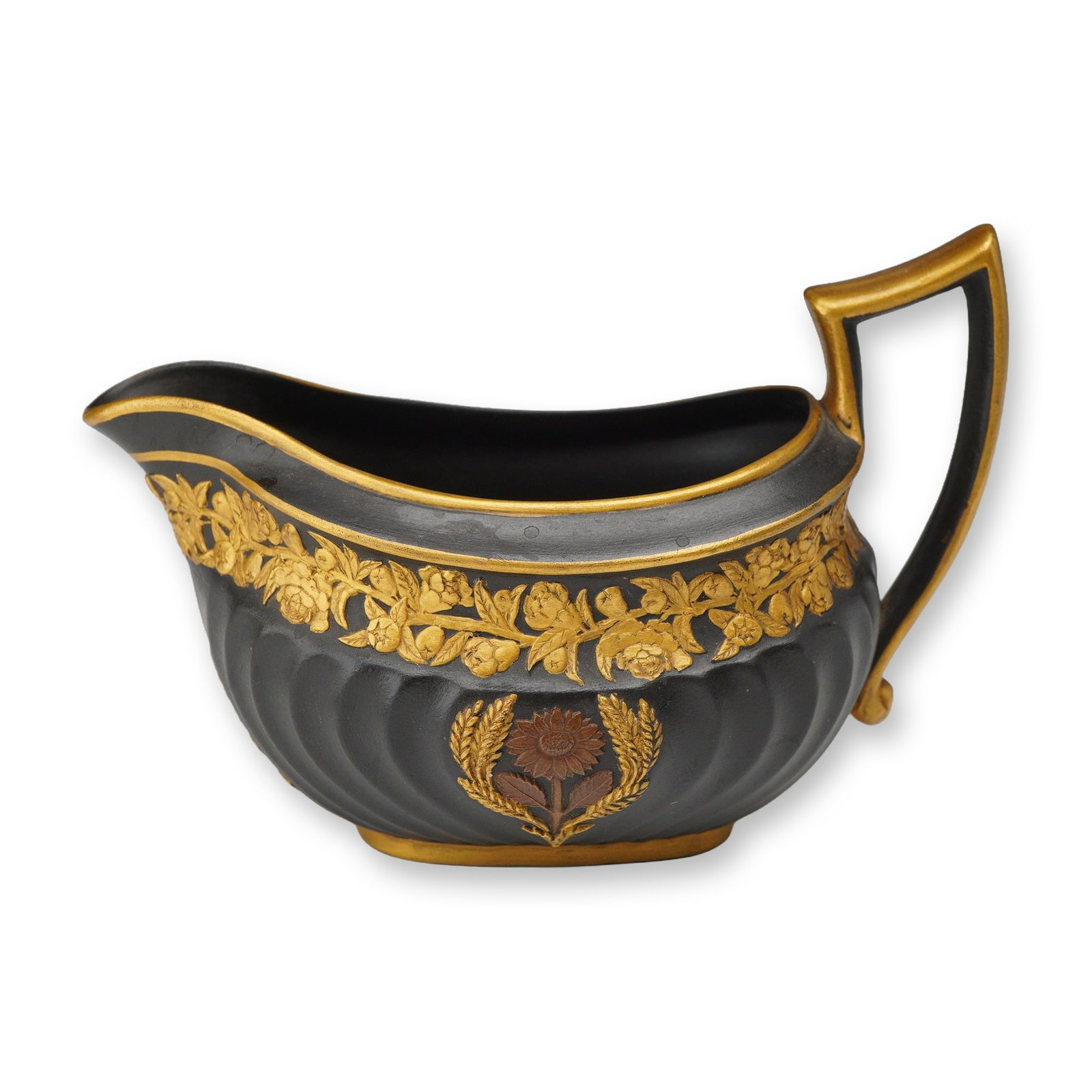 Wedgwood Bronze and Gilt Black Basalt Creamer Boat: A 19th-century Wedgwood black basalt creamer boat featuring a wide, low body with vertical fluted ribbing and a prominent angular handle. The vessel is constructed of unglazed black basalt stoneware. 