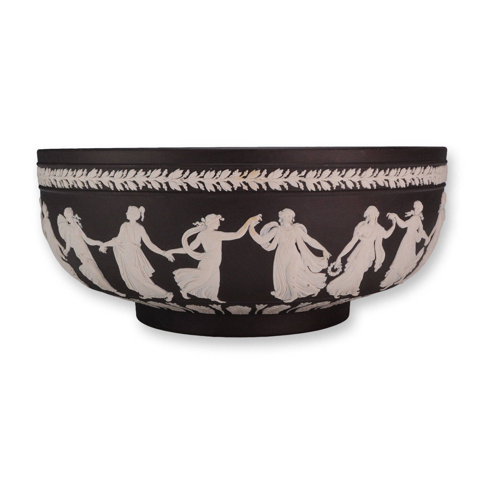 Wedgwood Black Jasperware Dancing Hours Bowl: A large footed bowl manufactured by Wedgwood in black jasperware, a fine-grained, unglazed stoneware. The vessel features a matte black body decorated with white sprigged relief in the neoclassical st