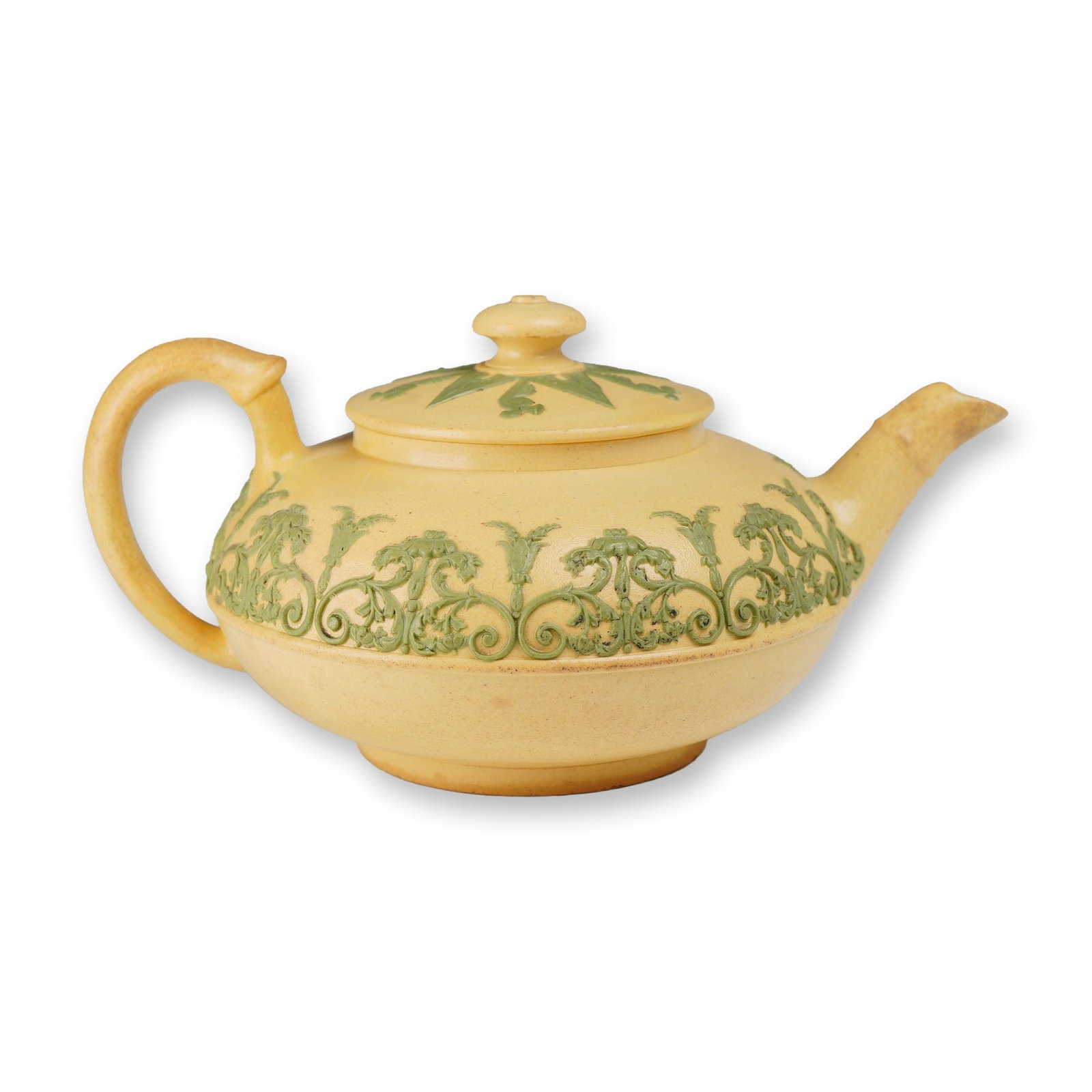 Wedgwood Caneware and Green Sprigged Jasperware Lidded Squat Teapot: Wedgwood caneware teapot featuring green sprigged relief decoration. The buff-colored unglazed stoneware body is of globular, squat form and is decorated with an applied green relief band of scrolling