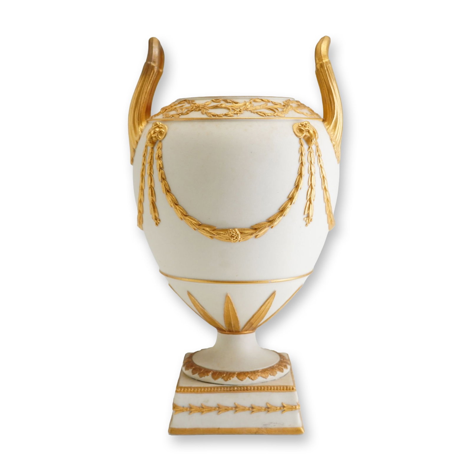 Wedgwood Gilded White Jasperware Trophy Urn: A Neoclassical-style trophy urn manufactured by Wedgwood, featuring a white jasperware or biscuit porcelain body with applied gilded ornamentation. The vessel has an ovoid form decorated with heavy la