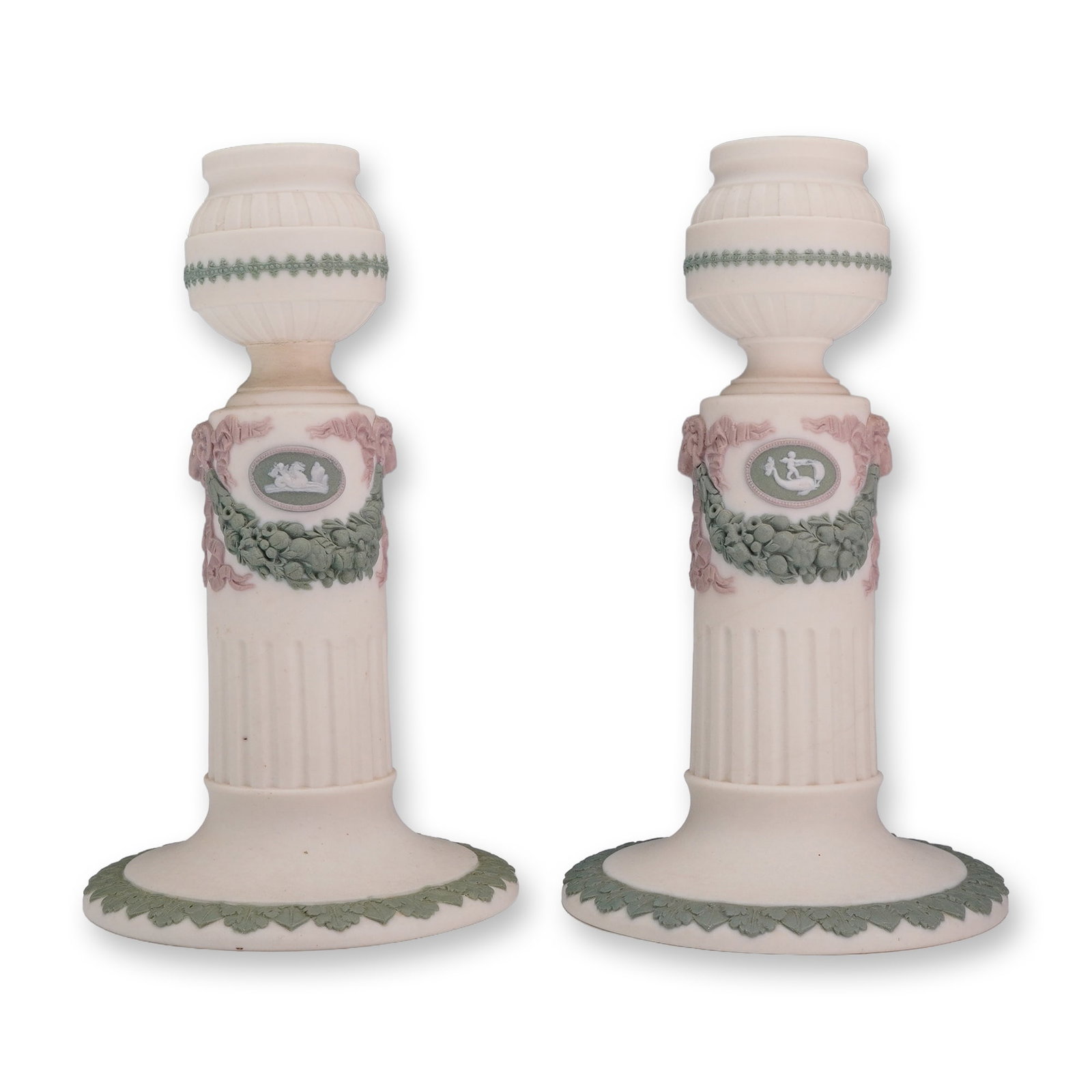 Pair of Wedgwood Tricolor Jasperware Columnar Candlestick Holders: This pair of Wedgwood jasperware candle holders is crafted from unglazed stoneware in a tri-color scheme consisting of a cream-colored body with sage green and lilac-pink sprigged bas-relief decoratio