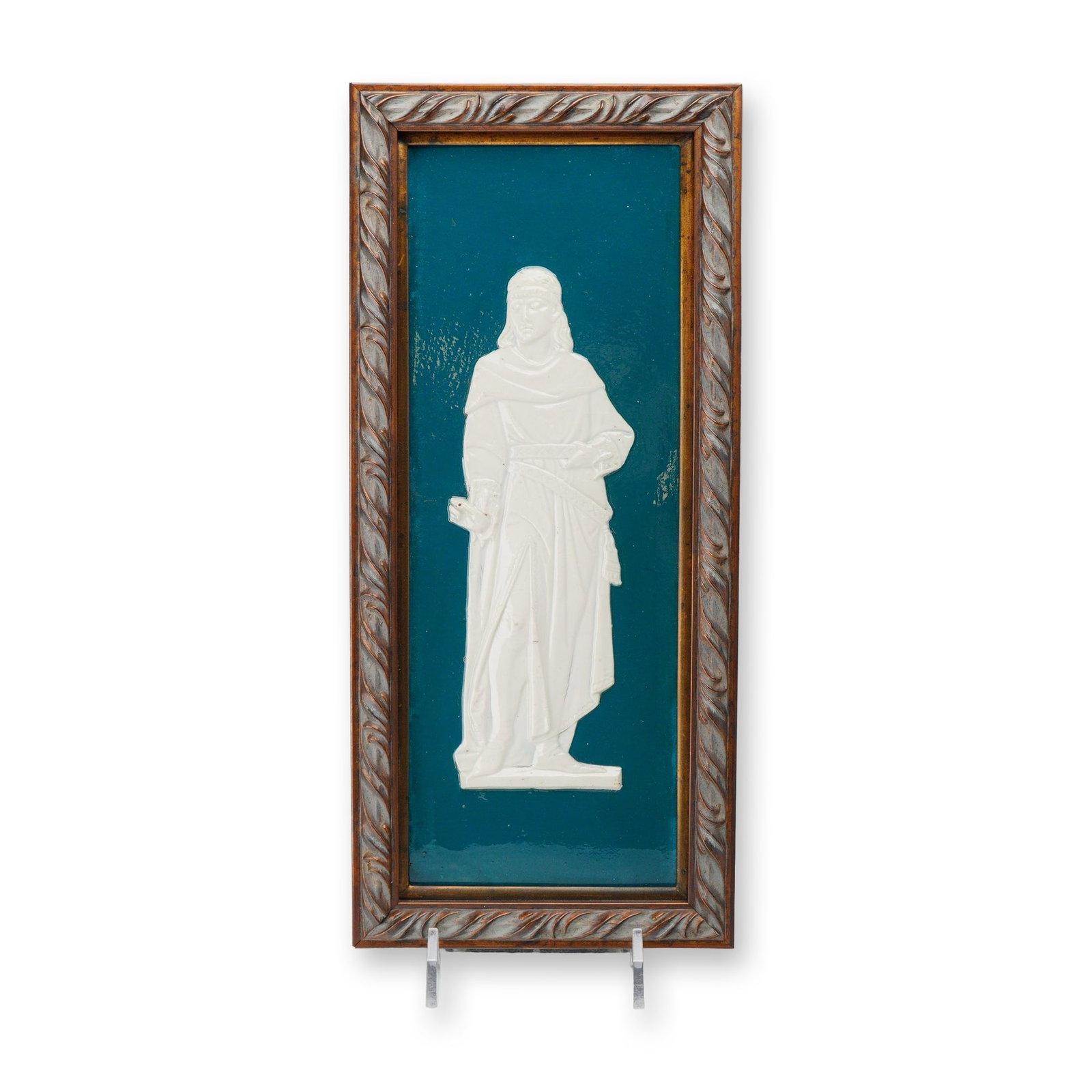 Wedgwood Jasperware Framed Plaque Depicting a Medieval Man: A rectangular ceramic plaque featuring a high-relief molded figure of a man in medieval-style attire, rendered in white stoneware against a deep teal jasperware ground. The clean-shaven figure is depi