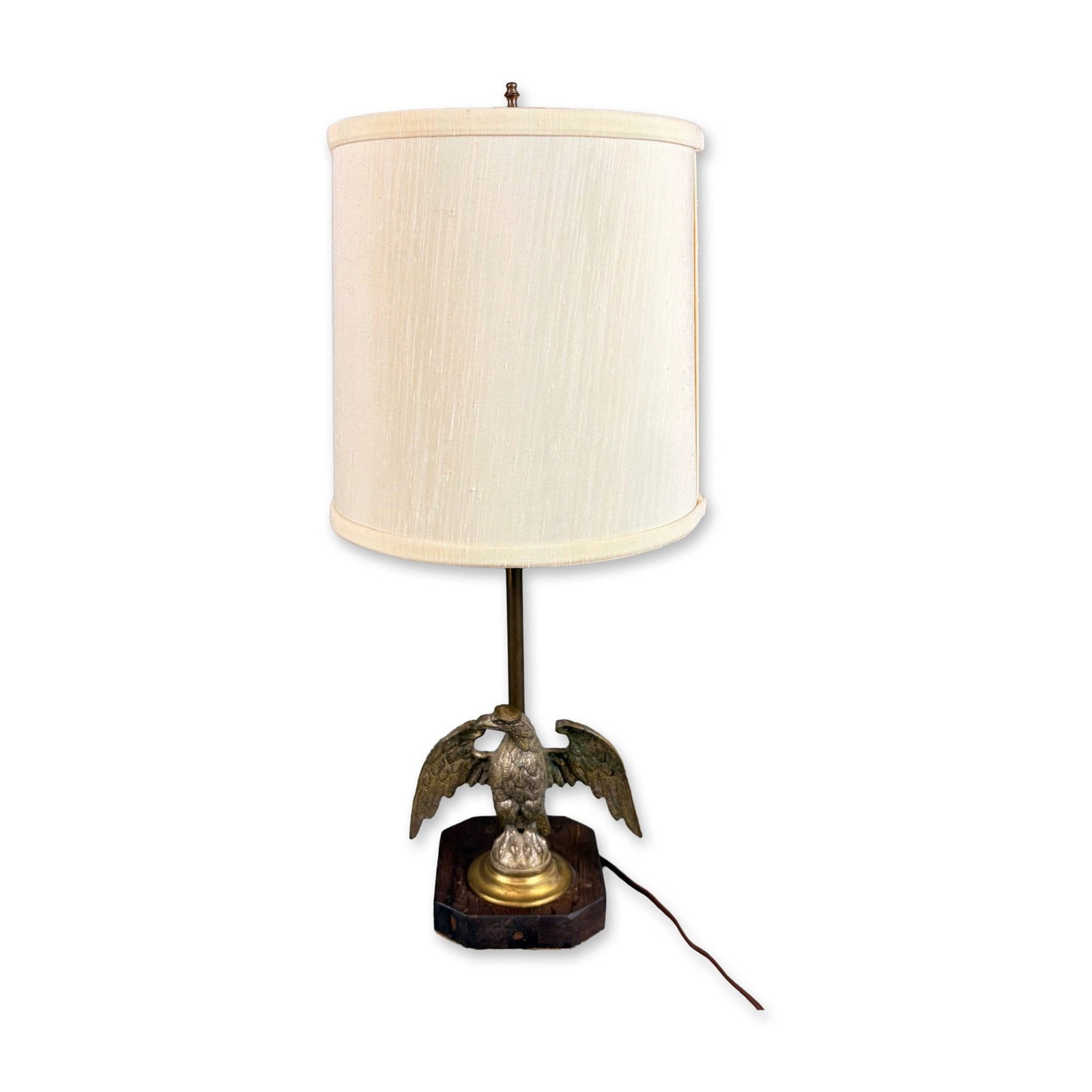 American Federal Style Cast Metal Eagle Table Lamp on Wooden Base: This table lamp is designed in the American Federal style, featuring a cast metal eagle with spread wings as the primary decorative element. The eagle figure is finished in a brass tone and is