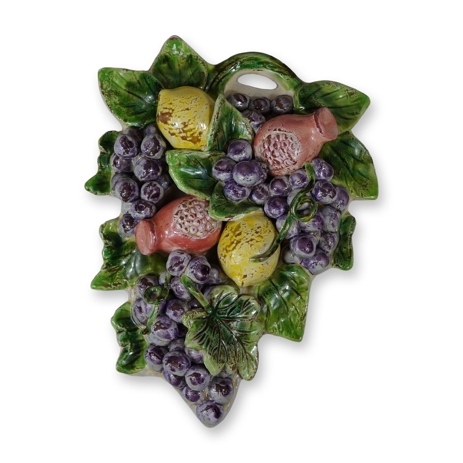 Polychrome Glazed Terracotta Fruit and Foliage Wall Plaque: This is an high-relief ceramic wall-hanging plaque crafted from polychrome glazed terracotta. The piece features a lush three-dimensional arrangement of fruit, including clusters of purple grapes,