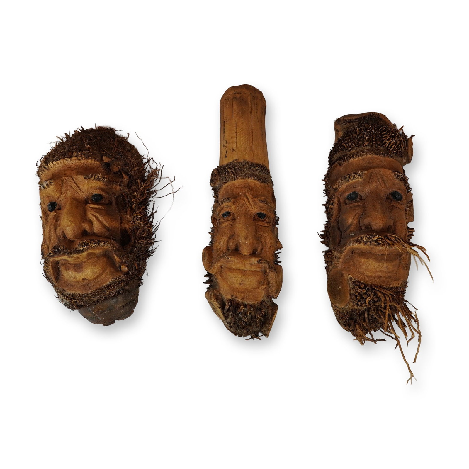Trio of Chinese Carved Bamboo Root Bearded Faces: Chinese folk art. Trio of hand-carved wood and roots hanging bearded faces wall decorations, fashioned from sections of bamboo root. The carvings depict expressive male faces with prominent noses and
