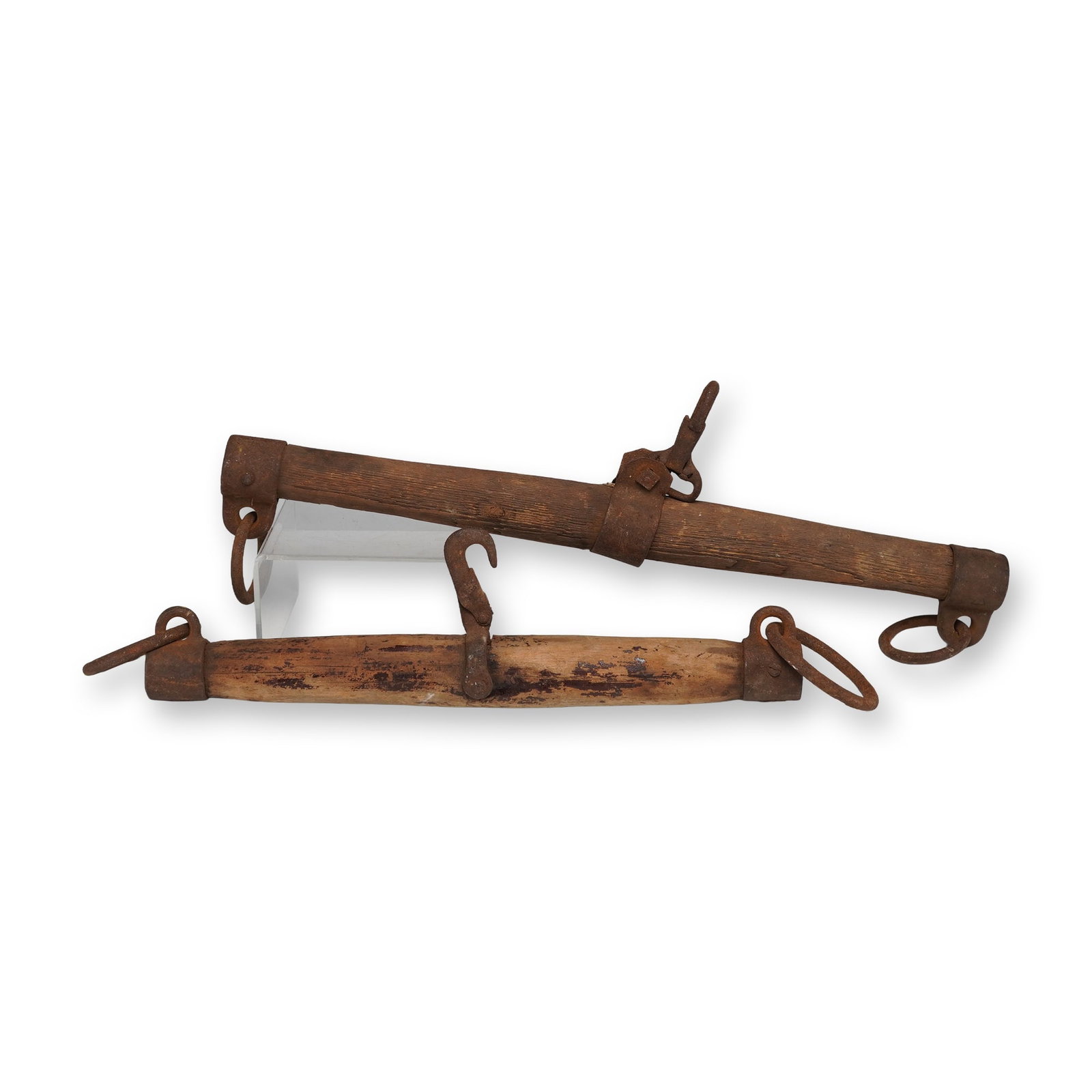 Pair of Wooden Horse Yokes with Iron Hardware: This pair of wooden horse yokes features sturdy wood with original iron hardware, including large rings and hooks for harnessing draft animals. The weathered wood and rusted iron show signs of authent