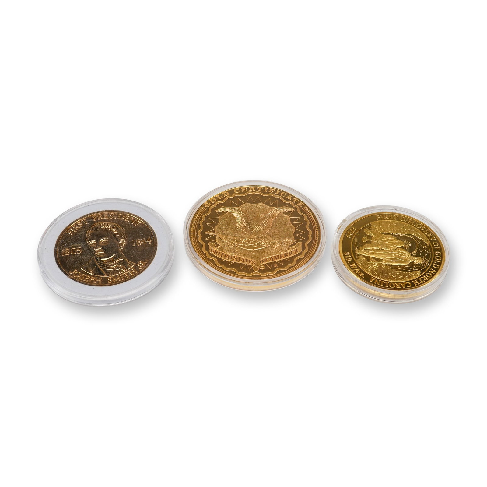 Three Commemorative Coins by American Mint Featuring Abraham Lincoln and Joseph Smith Jr.: Each item is housed in a clear protective plastic capsule. The collection includes a Joseph Smith Jr. medal marked First President 1805-1844 with a reverse depicting the Salt Lake Temple of the Church
