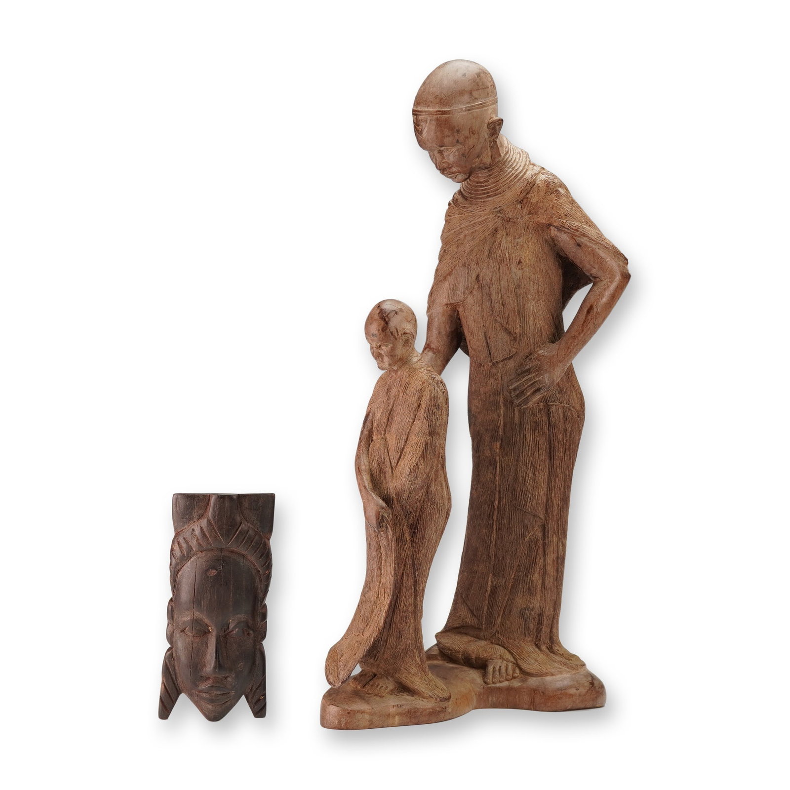 2pc Wooden African Woman and Child Sculpture and Small Mask Carving: A two piece grouping featuring a carved wood sculpture of a woman with a child, presented in an East African style consistent with Kenyan or Tanzanian carving traditions and signed on the underside. T