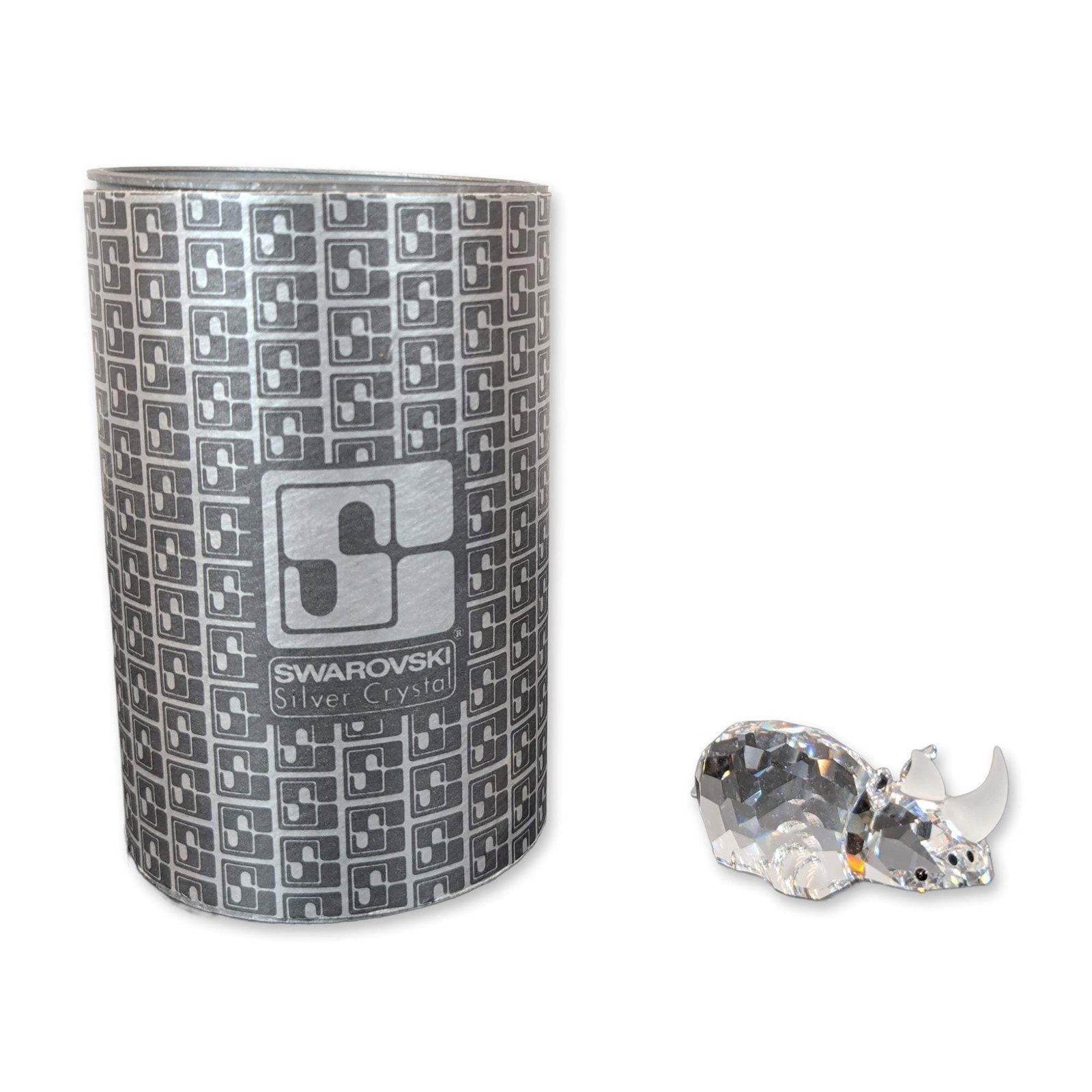 Swarovski Crystal Rhinoceros Figurine: Swarovski Silver Crystal rhinoceros figurine featuring a faceted lead crystal body with frosted crystal horns and small dark inset eyes. The underside of the piece is marked with the etched Swarovski 