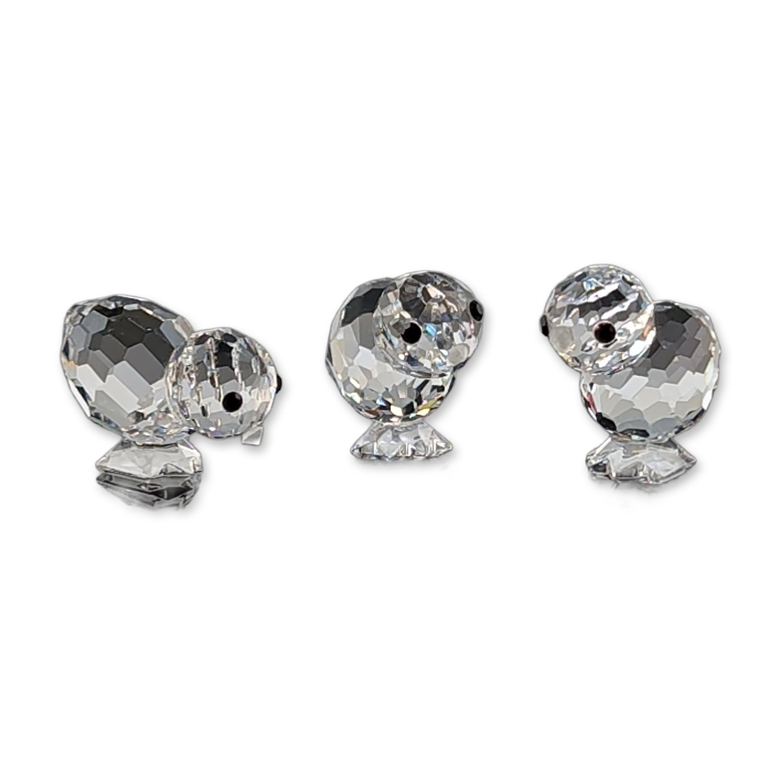 Swarovski Silver Crystal Mini Chicks Set: Set of three miniature chick figurines in faceted clear lead crystal, each constructed from precision-cut components including frosted beaks and black crystal eyes. Acid-etched swan maker mark and ini