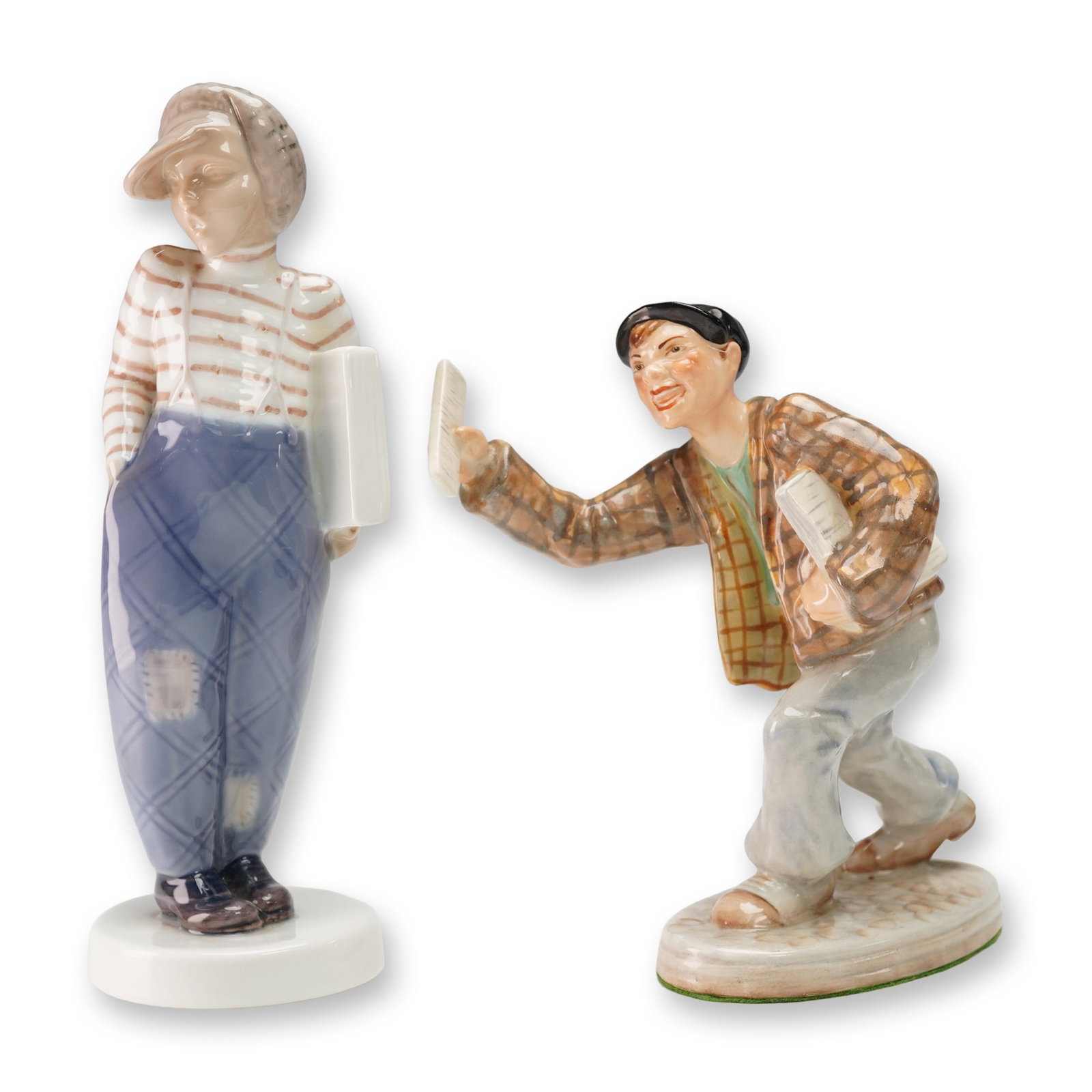 2pc Wedgwood & Co. and Bing & Grondahl Porcelain Figurines: Lot of two hand-painted porcelain figurines including Wedgwood & Co.'s Paper Seller depicting a lively young vendor mid-call, dressed in a checked jacket and cap while holding up a newspaper, and Bing