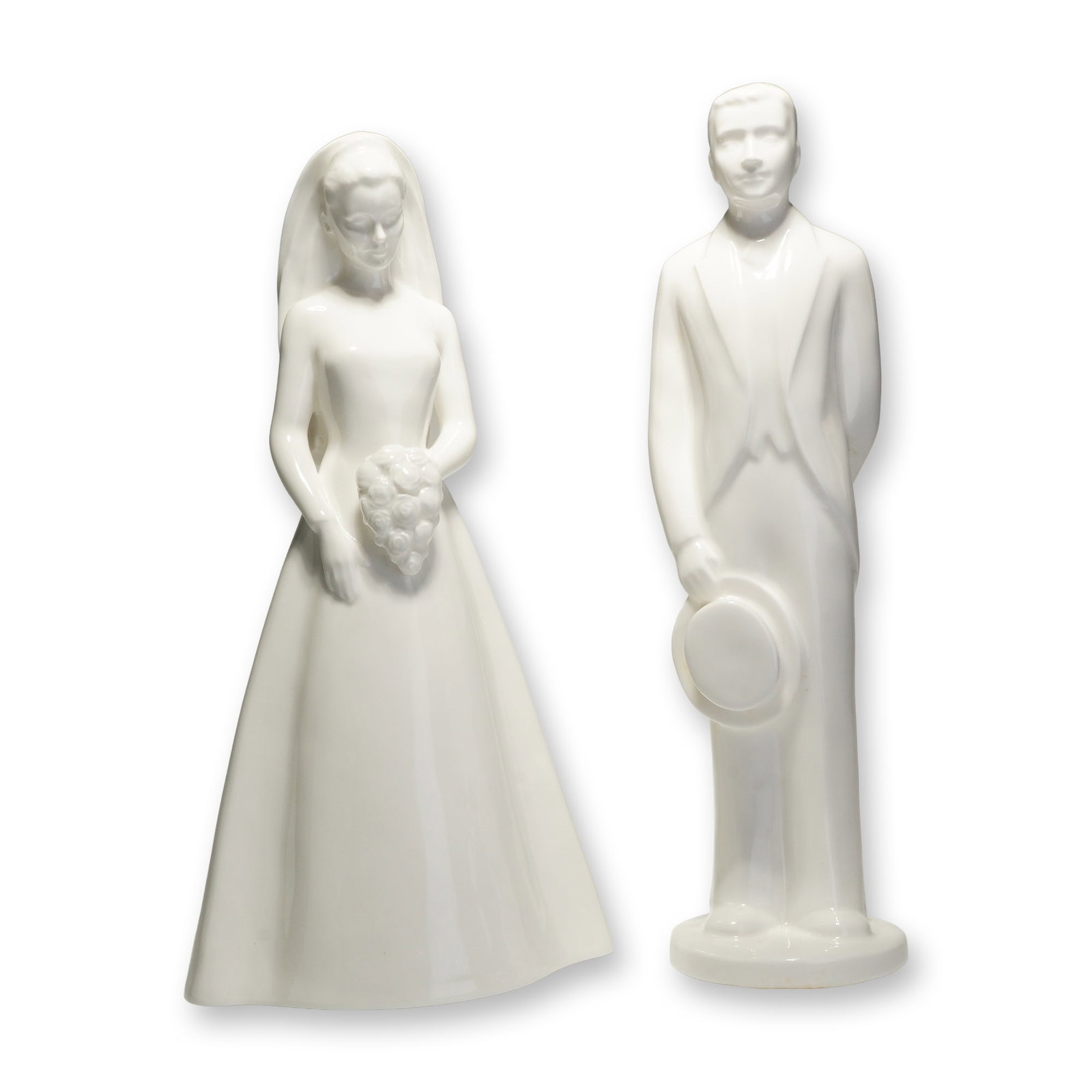 2pc Coalport Moments Bone China Figurines, The Bride and The Groom: A duo of white glazed bone china figurines from the Moments by Coalport collection, titled The Bride and The Groom. These contemporary-style figures are rendered with a high-gloss monochromatic finish