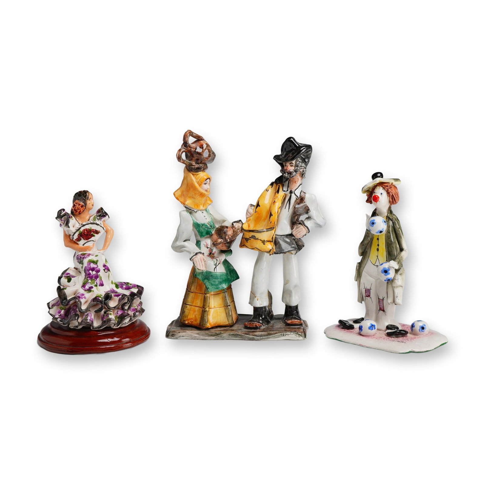 Three Hand Painted Ceramic Figurines including Stelio Mola and Zampiva: This collection consists of three handmade glazed ceramic figurines of Italian and European origin. The first is a Sardinian folk art sculpture by Stelio Mola, depicting a couple in traditional