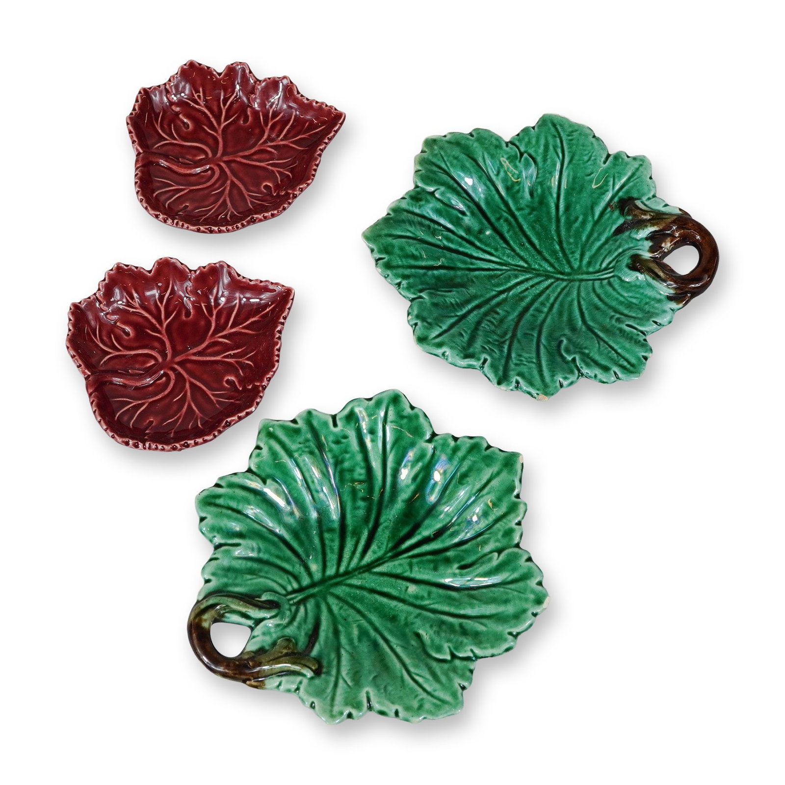 4pc Olfaire Portuguese Majolica Glazed Leaf-Shaped Dishes: This 4pc collection of leaf shaped dishes features Portuguese majolica-style glazed earthenware manufactured by Olfaire. The assortment consists of two green and brown majolica dishes and two reddish-