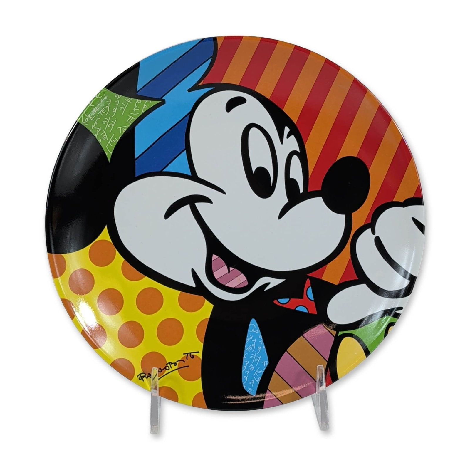 Disney by Britto Mickey Mouse Ceramic Plate: Decorative ceramic plate featuring a pop-art interpretation of Mickey Mouse. The circular glazed surface is decorated with bold black outlines and vibrant multi-colored patterns including horizontal s