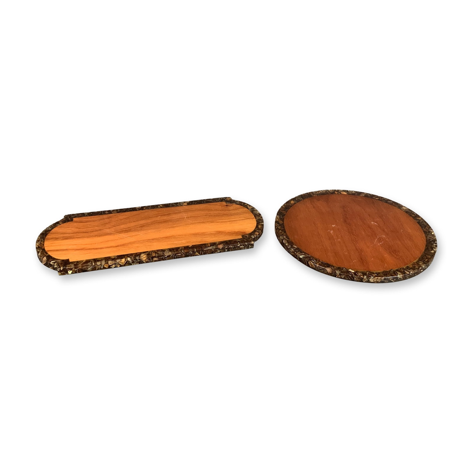 Two Mid-Century Wood and Resin Serving Boards: This lot features two handmade serving boards constructed in a mid-century craft style. Each board is composed of a central wooden panel with visible grain, possibly cherry or acacia, surrounded by a