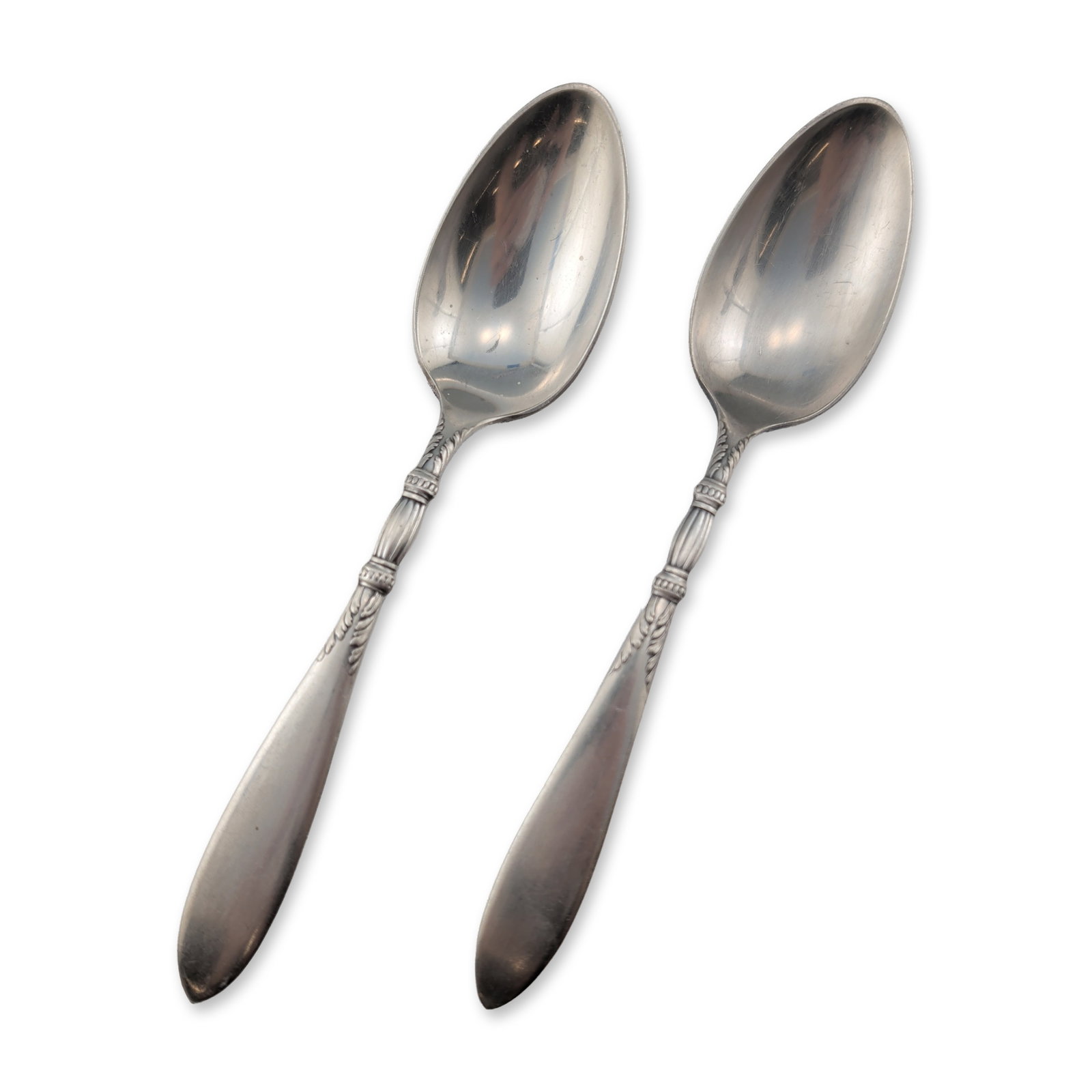 Pair of 1847 Rogers Bros Silverplate Spoons: 1847 Rogers Bros. Pair of spoons in silverplated base metal, featuring the Queen Ann pattern, also known as St. Moritz, introduced circa 1910. The neoclassical design includes a reeded baluster handle