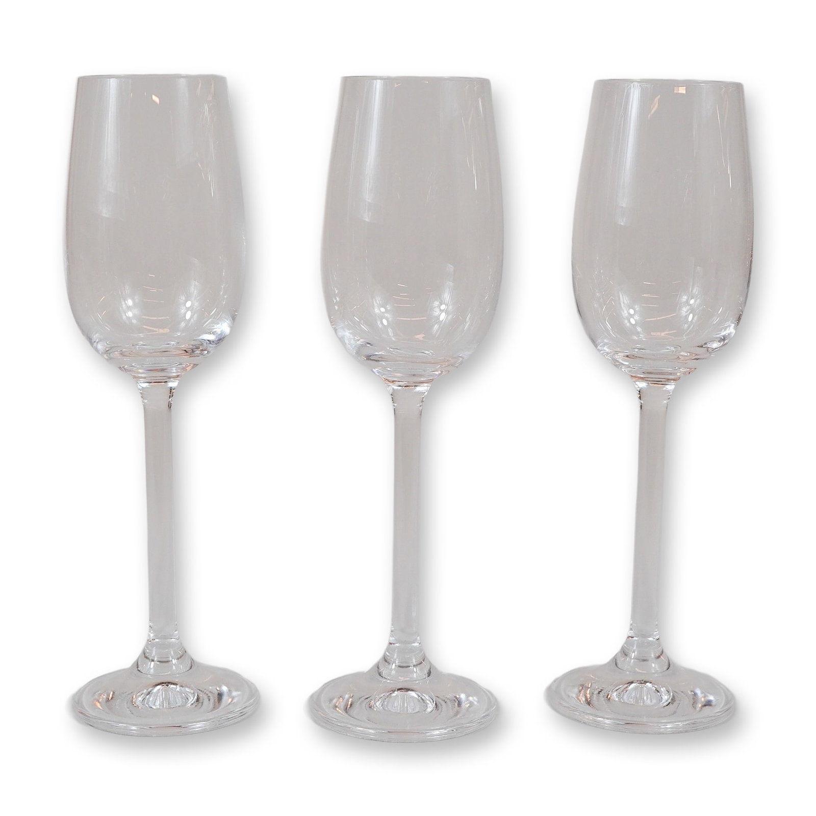 3pc Contemporary Clear Glass Champagne Flutes: A set of three matching contemporary clear glass stemware pieces, designed as champagne flutes. Each piece features a tall, narrow tulip-form bowl that tapers slightly toward the rim, supported by a l