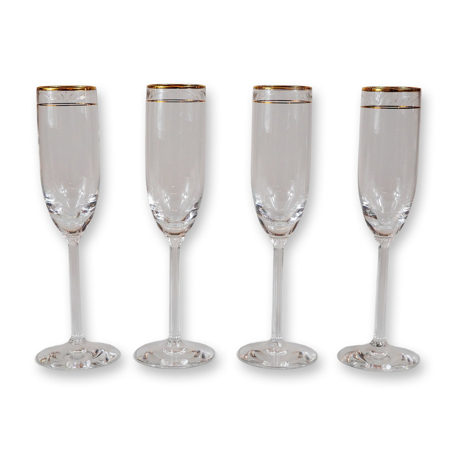 4pc Lenox Fluted Champagne Glasses, Kingston: A set of four clear glass champagne flutes featuring straight sides and a formal decorative border. The upper portion of each vessel is adorned with a wide gold band at the rim, followed by a delicate