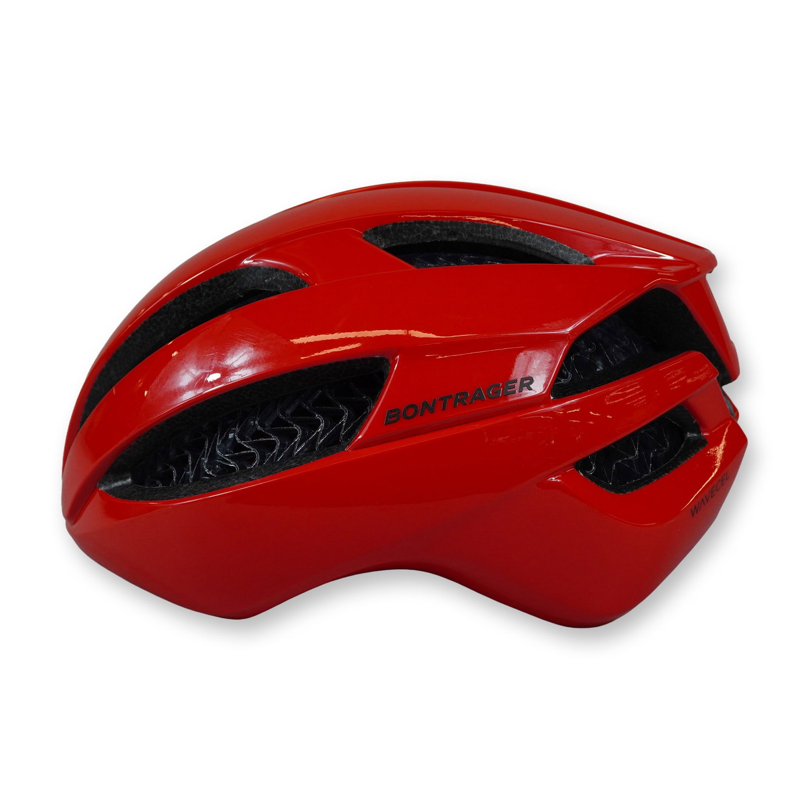 Bontrager Specter WaveCel Red Cycling Helmet: Bontrager. Specter WaveCel bicycle helmet in glossy red and black, featuring a vented aerodynamic profile. The construction includes a black collapsible cellular WaveCel liner, red interior padding, a