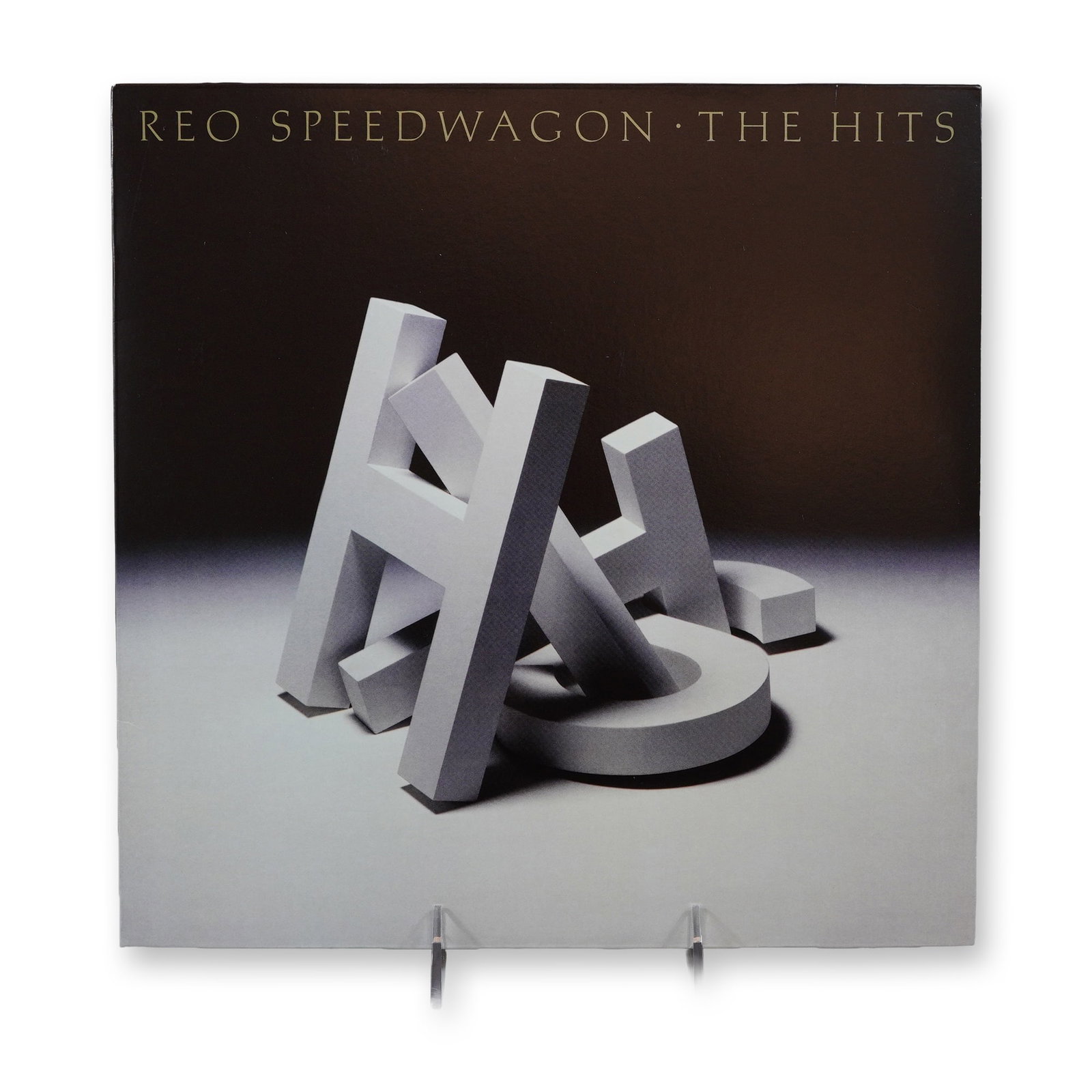 REO Speedwagon The Hits Vinyl LP Record: REO Speedwagon, The Hits. Single 12-inch vinyl LP, 2020 reissue of the 1988 compilation. Epic Records, catalog number 19439764001 (barcode 194397640014). The jacket features original 1988 artwork