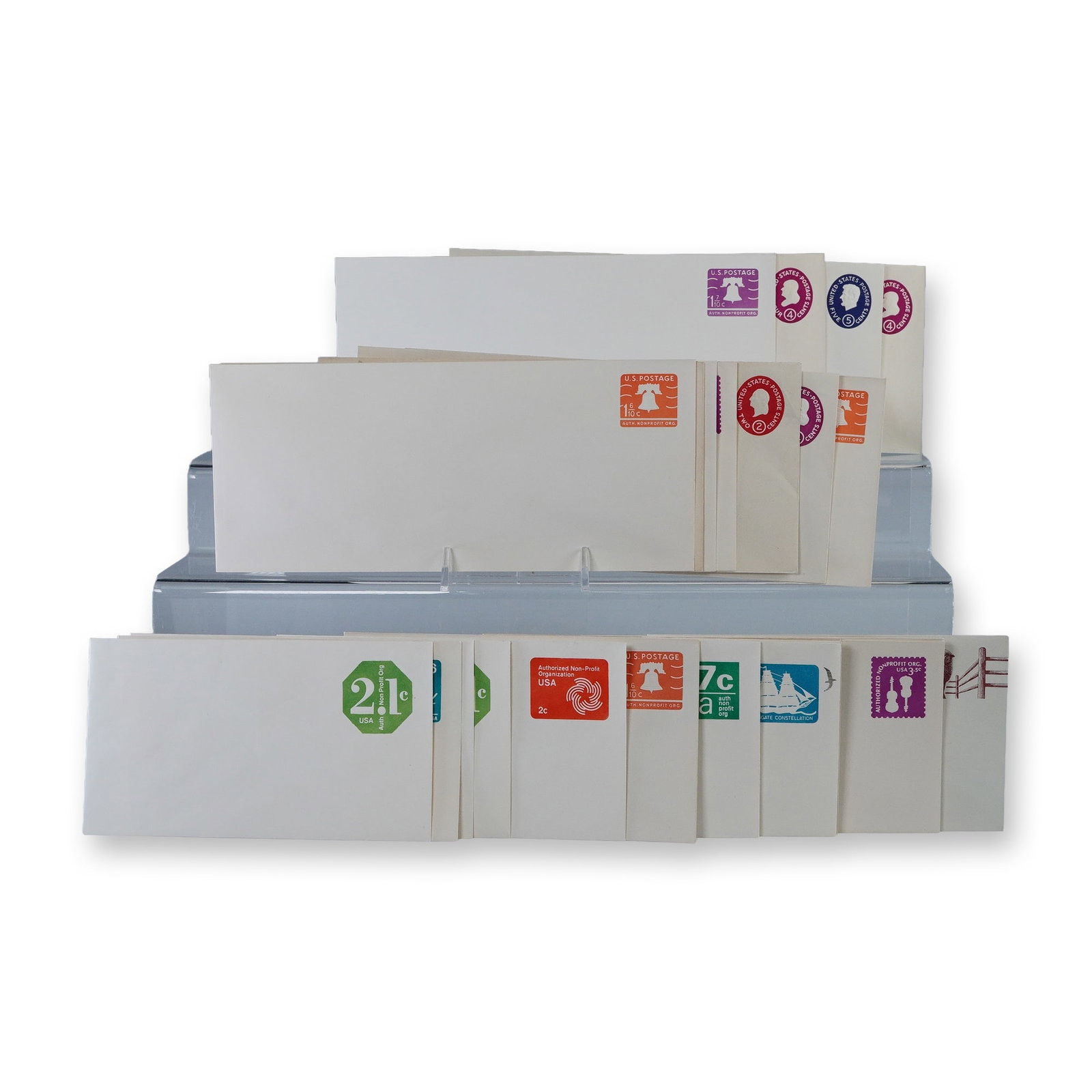 27pc Vintage US Postal Stationery Envelopes: Collection of thirty vintage United States postal stationery envelopes with pre-printed postage in assorted denominations and designs. Includes colorful examples featuring motifs such as the Liberty