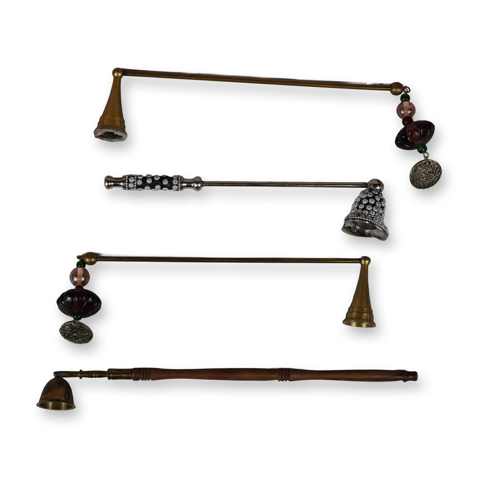 4pc Candle Snuffers Including Brass, Wood, and Decorative Metal Examples: 4pc candle snuffers featuring an assortment of decorative and functional designs. The collection includes two brass snuffers with thin rod handles, each finished with a hanging charm assembly