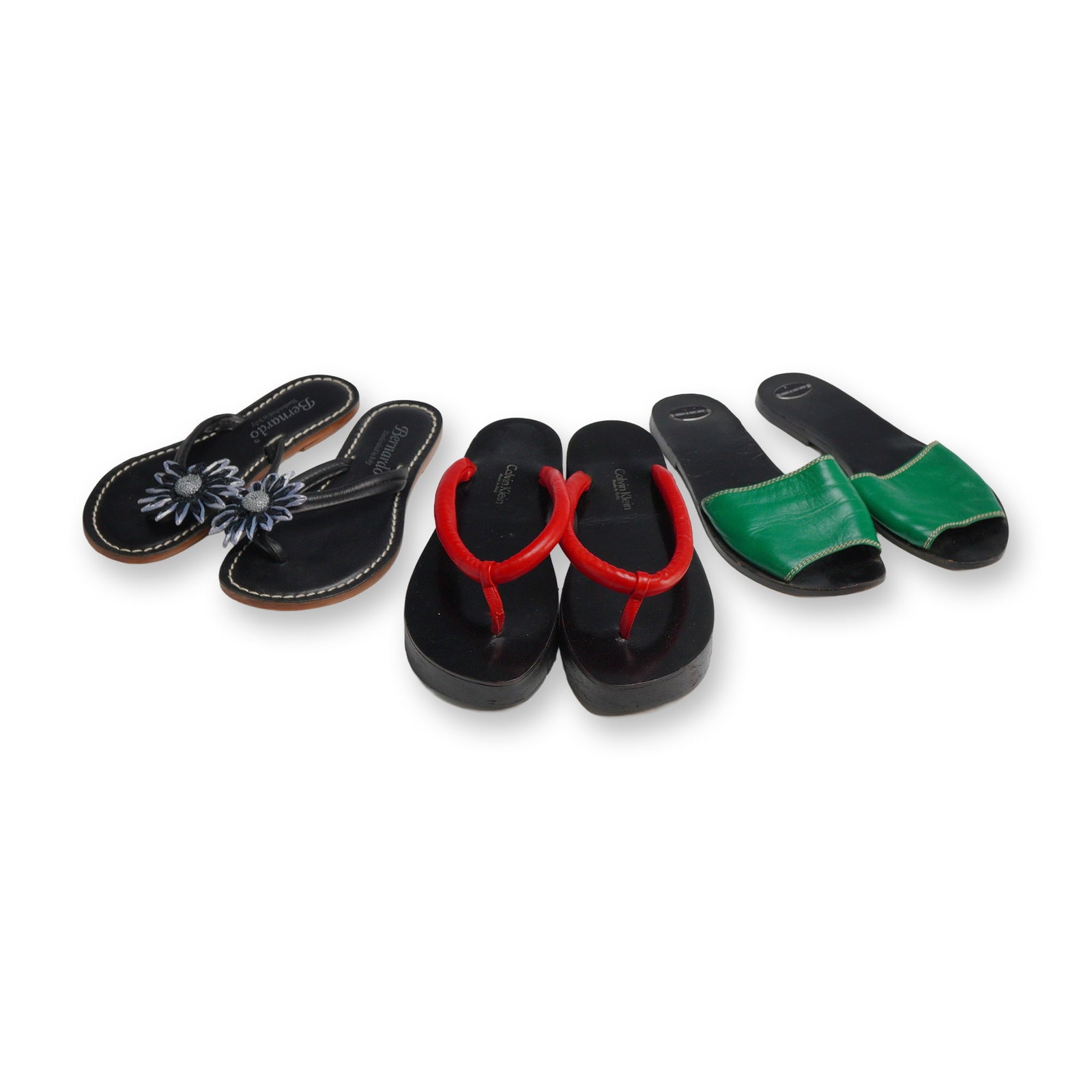Three Pairs of Designer Summer Sandals: Calvin Klein, Bernardo, and Fausto Santini: This lot features three pairs of Italian-made designer summer slides and shoes. The first pair consists of Bernardo Miami thong sandals, size 5M, handcrafted in Italy from black leather with white con