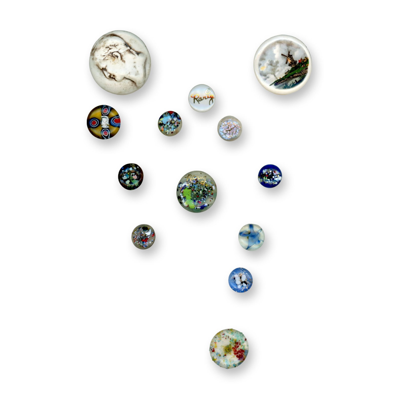 A CARD OF STUDIO ARTIST BUTTONS: 13 S/M/L 20th century Theresa Rarig studio buttons. Theresea Rarig was not just a glass worker and didn't just male paperweight buttons, she worked in ceramics also. Included here are several of her e