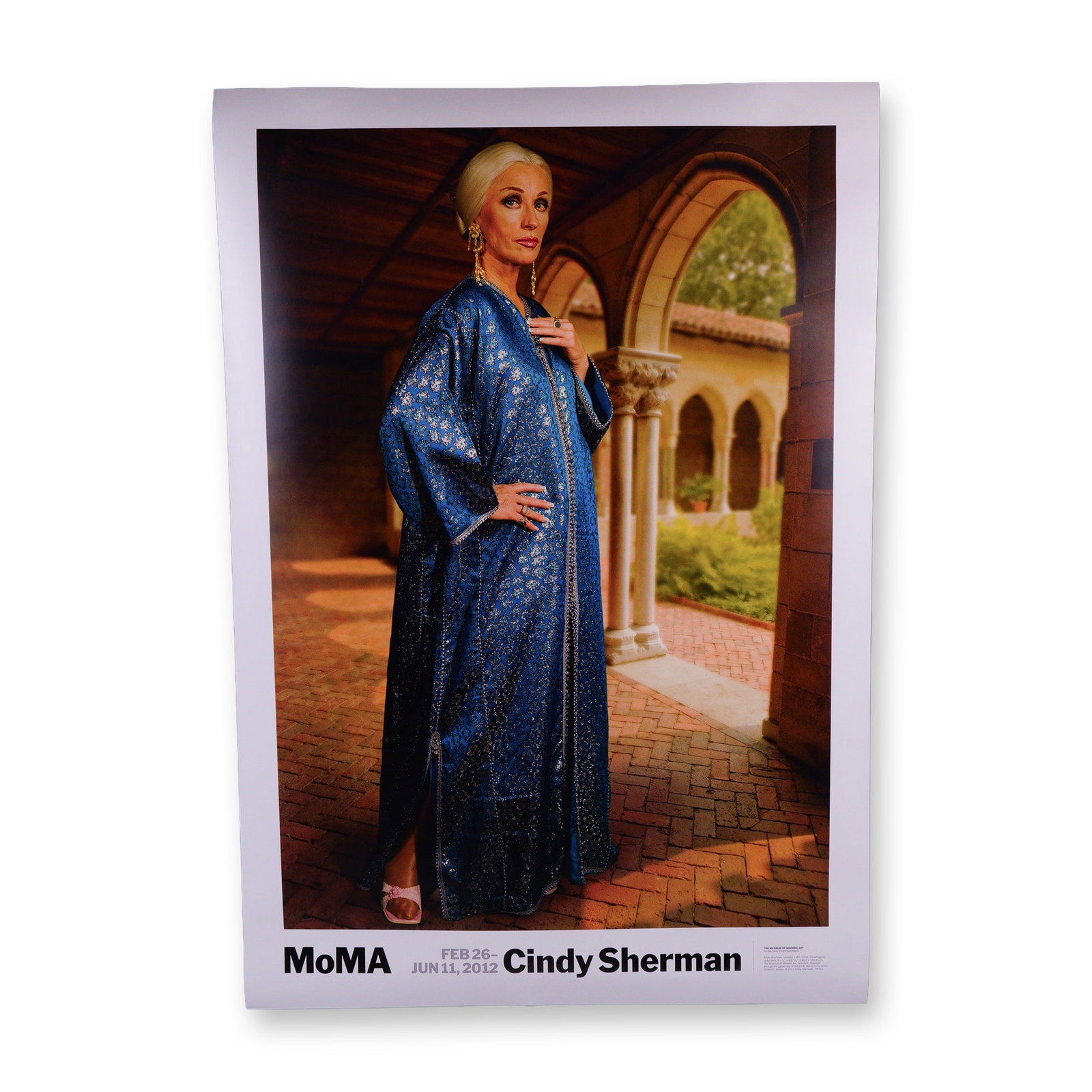 Cindy Sherman 2012 MoMA Exhibition Poster w/ Untitled #466: A striking original exhibition poster from the Museum of Modern Art (MoMA), featuring Untitled #466 by the renowned American artist Cindy Sherman. This chromogenic color print depicts Sherman in one o