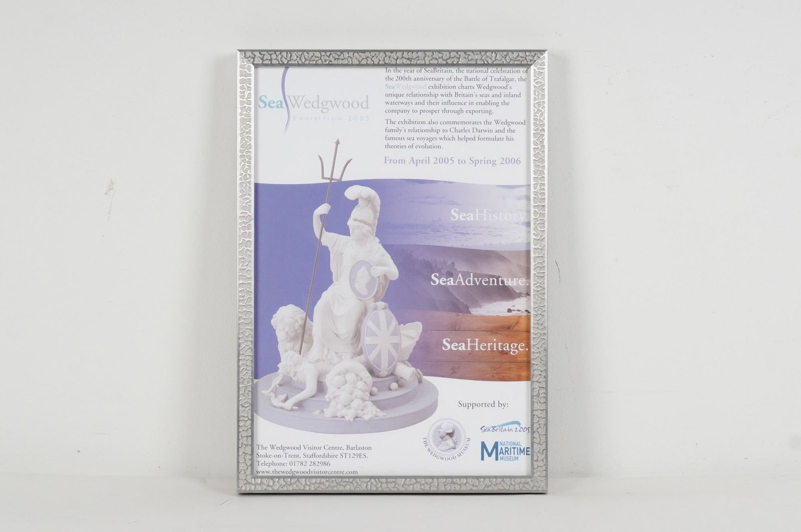 Framed Sea Wedgwood Exhibition Museum Poster: A framed Wedgwood poster advertising the "Sea Wedgwood Exhibition 2005" which ran from April 2005 to Spring 2006 in Staffordshire. Housed in a mat silver-tone frame. Dimensions: 11.75"L x 1.25"W x 16.