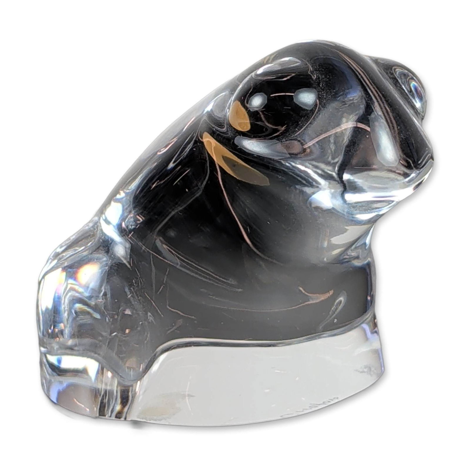 Orrefors Swedish Crystal Frog Figurine: Orrefors (Sweden). Seated frog figurine in clear lead crystal, featuring a stylized animal form with smooth, rounded contours. Retains an original red and silver foil manufacturer label and an etched 