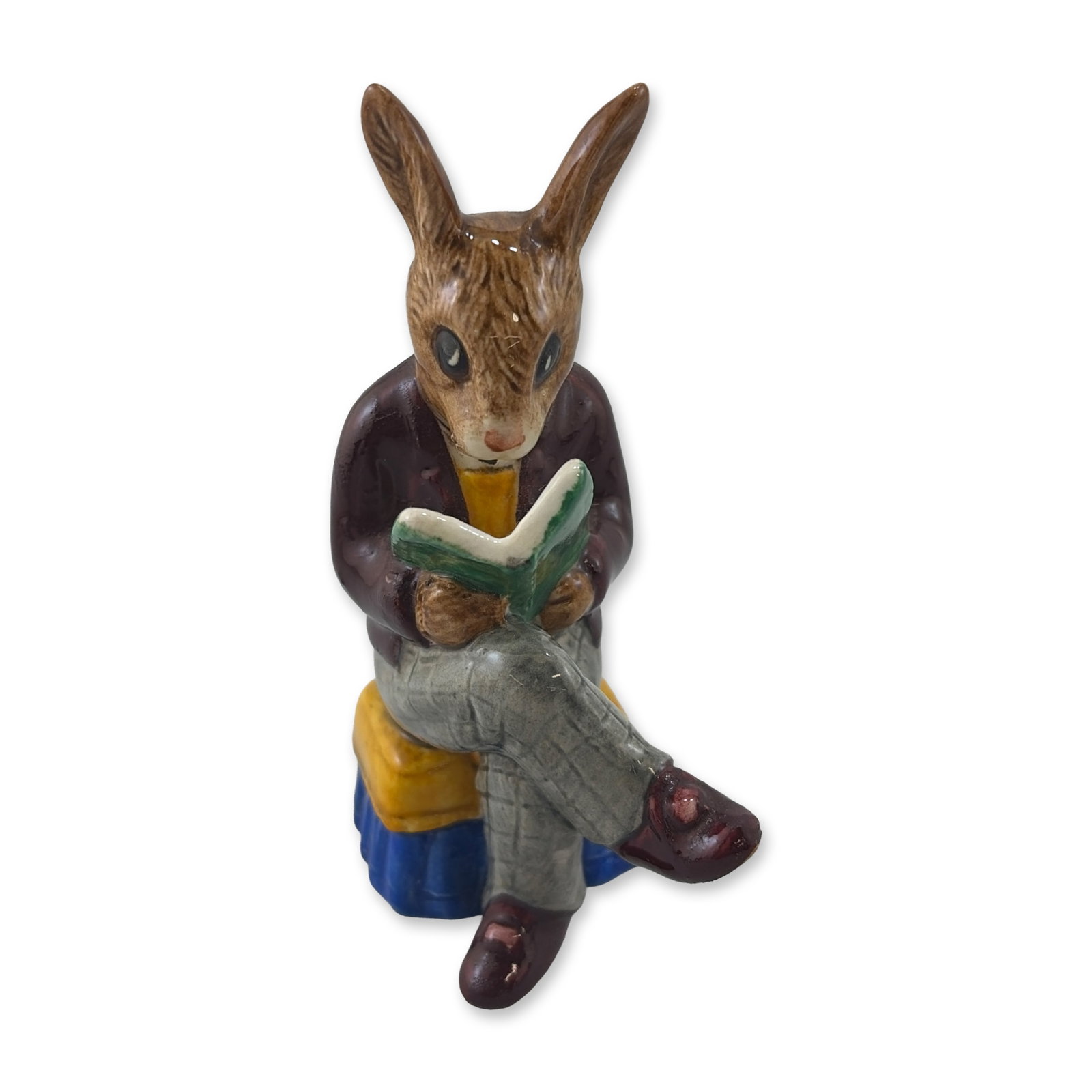 Royal Doulton Bunnykins Grandpas Story Figurine DB 14: Royal Doulton. Figurine in glazed porcelain from the Bunnykins series titled Grandpas Story. The piece depicts an anthropomorphic elderly rabbit character in a seated position reading a green book.