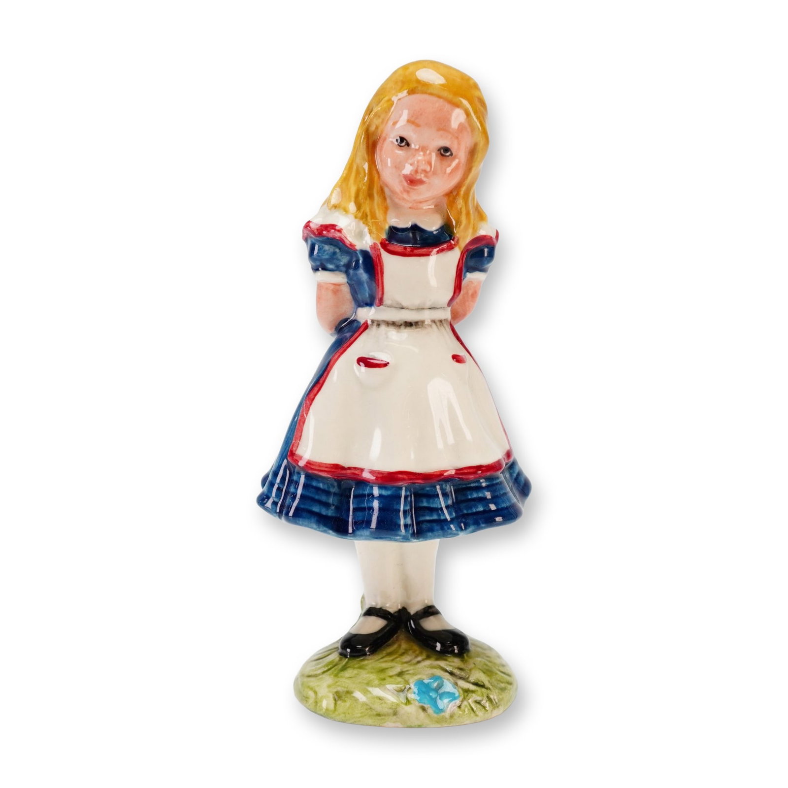 Beswick, Alice: This Beswick porcelain figurine Alice is part of the Alice Series based on the characters from Lewis Carroll's Alice's Adventures in Wonderland. The figure is depicted standing with her hands behind h