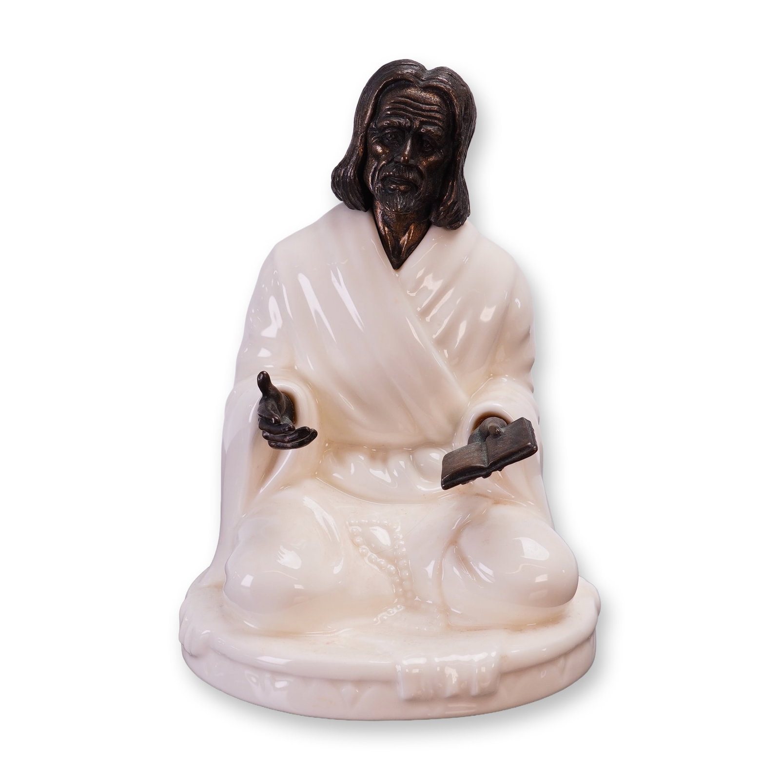 Minton Fine Bone China and Bronze Figurine The Sage MS25: A Minton fine bone china and bronze figurine titled The Sage, model number MS25, manufactured in England circa 1978. The piece depicts a seated male figure in a cross-legged position, wearing robes wi