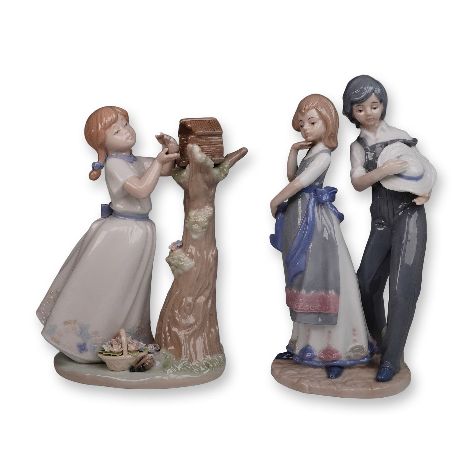 A Pair of Glazed Ceramic Figurines, one by Nadal, depicting children: A pair of Spanish glazed ceramic figurines. The first figurine, marked 'NADAL' with a crown logo, 'MADE IN SPAIN,' and 'LIMITED EDITION N? 1344 / 5000,' depicts a young girl with reddish-brown pigtail