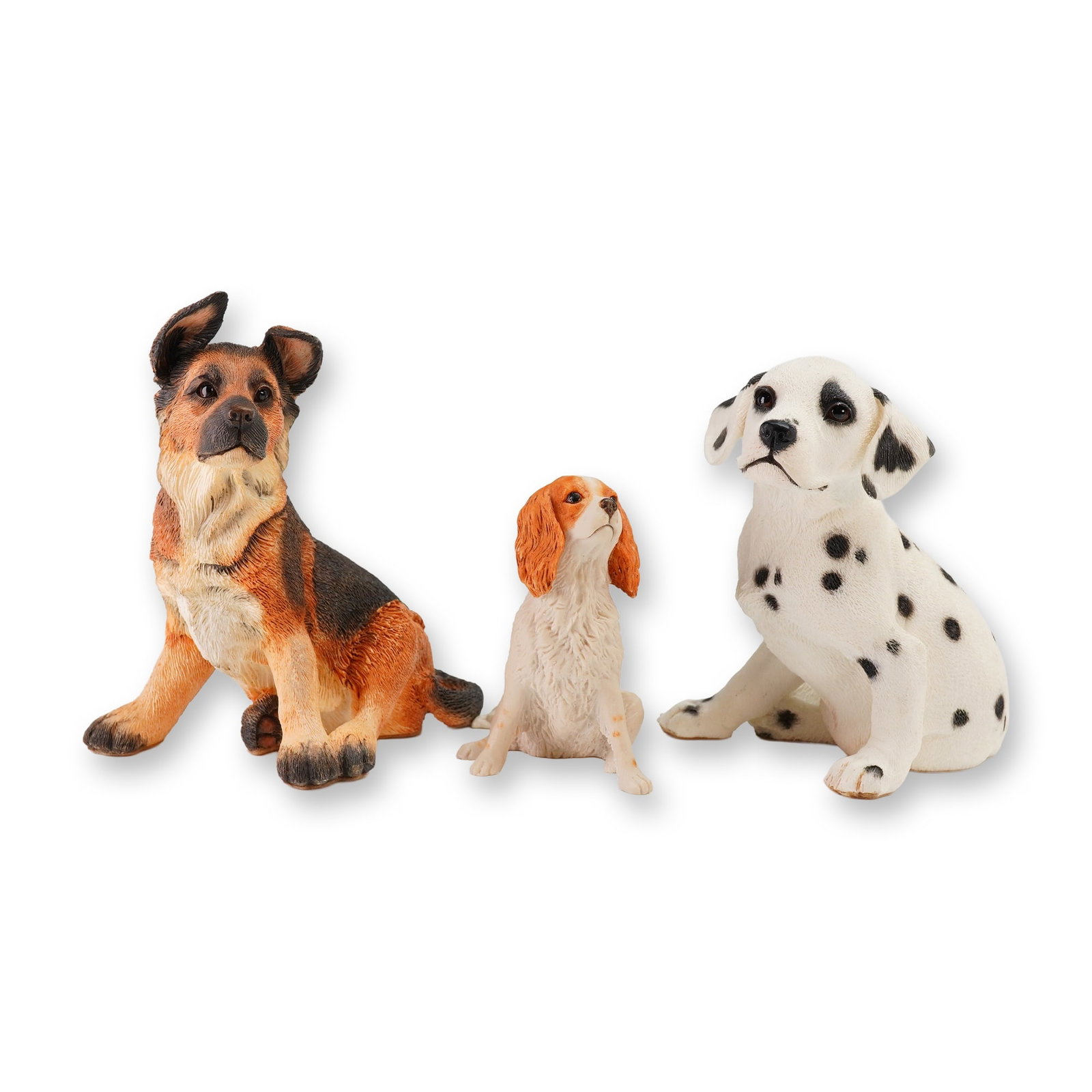 Three Resin Dog Figurines including Country Artists Alsatian Puppy: The collection includes an Alsatian puppy, a Dalmatian puppy, and a spaniel-type dog. Each figure is modeled with realistic fur textures and lifelike coloration. The Alsatian figure features a manufac