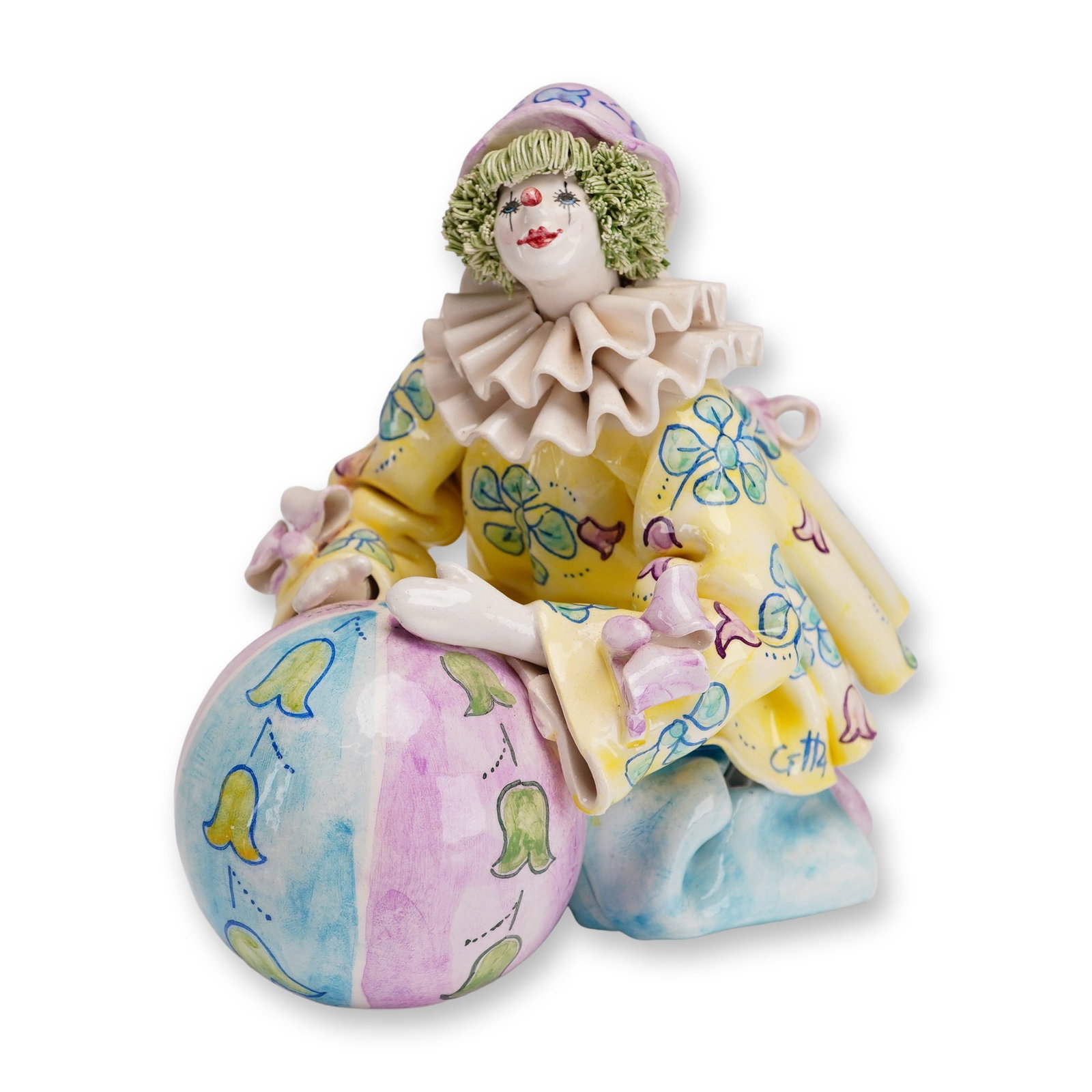 Gump's Italian Hand-Painted Ceramic Clown with Ball: This hand-painted ceramic figurine of a kneeling clown was produced in Italy as a custom retail item for Gump's, the luxury San Francisco department store. The figure is depicted holding a large, sphe