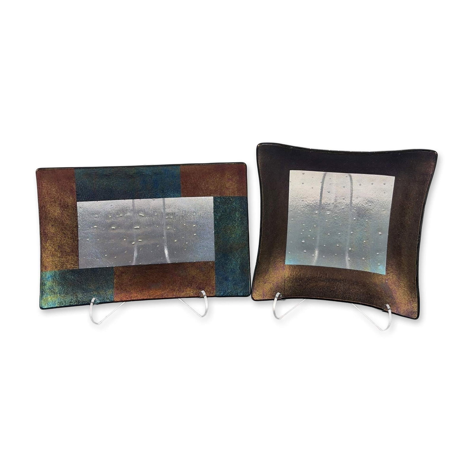 2pc Kurt McVay Fused Dichroic Art Glass Dishes: Pair of Kurt McVay contemporary studio art glass dishes in kiln-fused and slumped glass. Each vessel features a central silver-toned panel with controlled bubble inclusions and textured linear motifs,