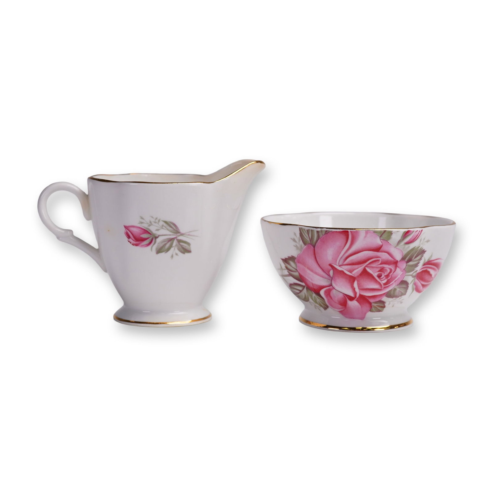 2pc Vintage Windsor Creamer and Sugar Bowl, Rose Motif: This charming vintage creamer and open sugar bowl set by Windsor Bone China features an elegant English rose motif in vibrant shades of pink, accentuated with lush green foliage. Crafted in England,