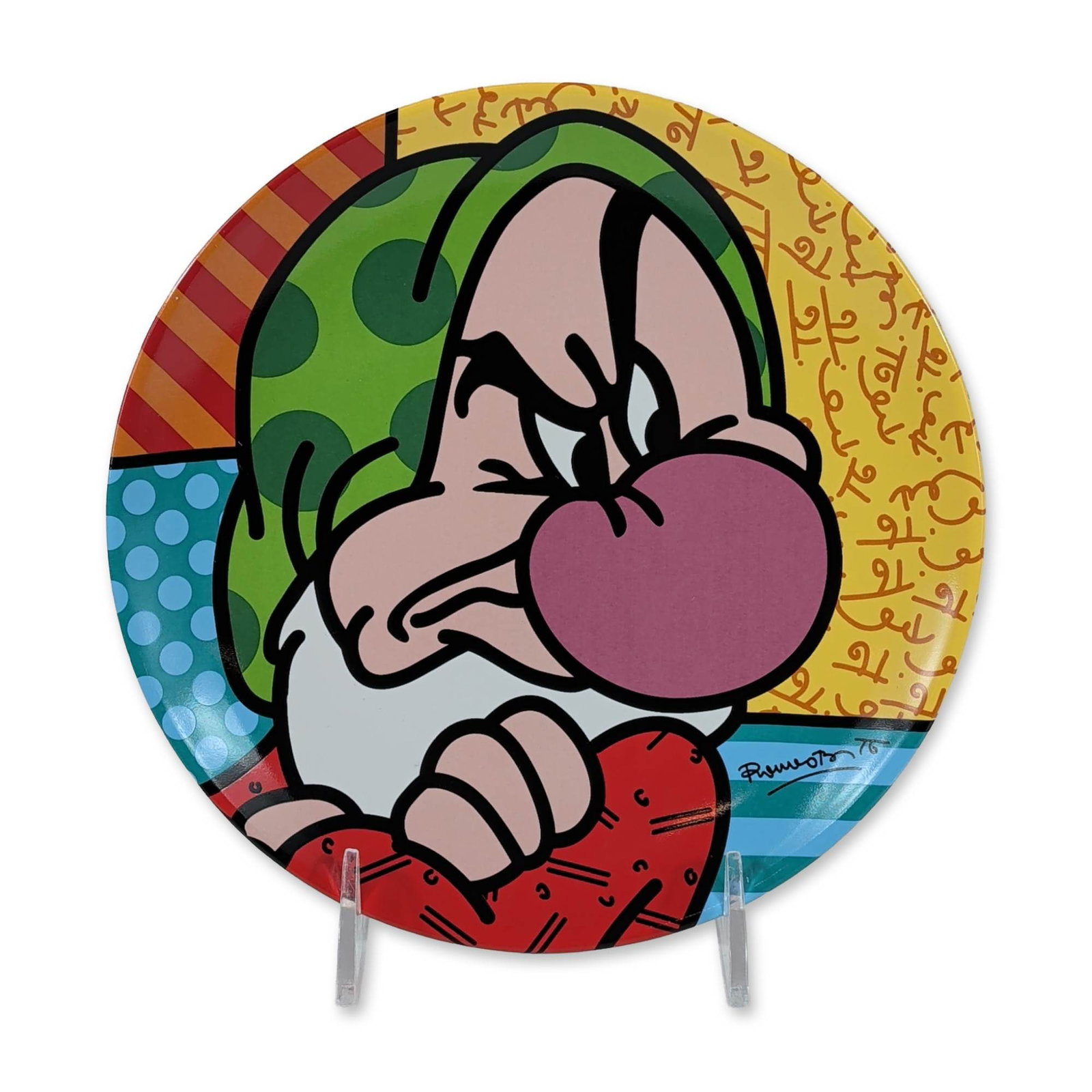 Disney by Britto Grumpy Ceramic Plate: Disney by Britto collection. Decorative round plate in glazed ceramic, featuring a pop-art illustration of the character Grumpy from Snow White and the Seven Dwarfs. The design utilizes vibrant colors