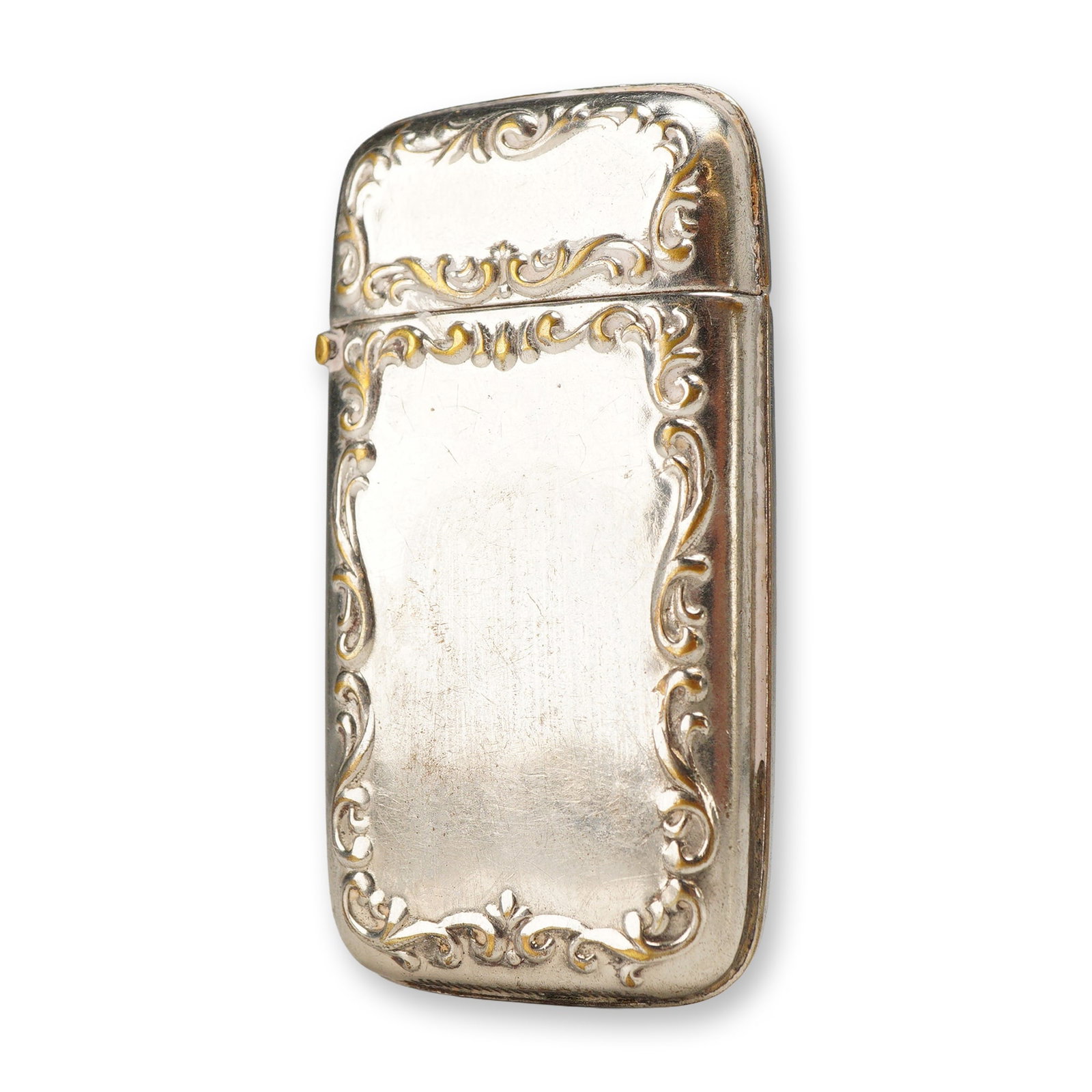 Late Victorian Style Silver-Plated Rococo Revival Vesta Case: A rectangular pocket vesta case, also known as a matchsafe, featuring ornate repousse rococo-style scroll and foliate borders on the front face and lid. The decorative relief retains some gilt-toned h