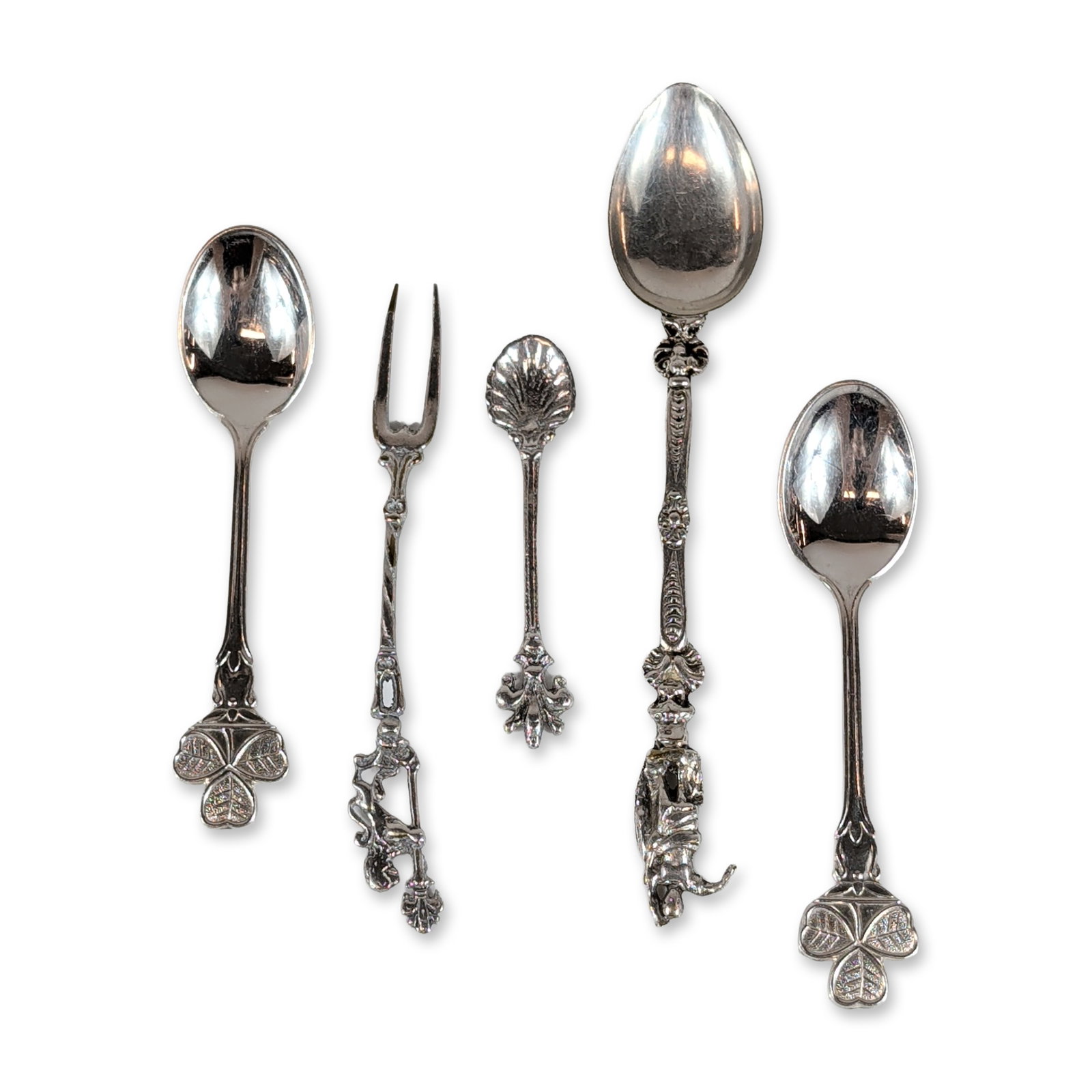 5pc Irish Silver-Plated Cocktail Fork & Sugar and Tea Spoons: Republic of Ireland souvenir flatware collection. Group of five pieces in silver-plated nickel silver (EPNS), including two spoons with openwork shamrock finials, a figurative spoon with a standing