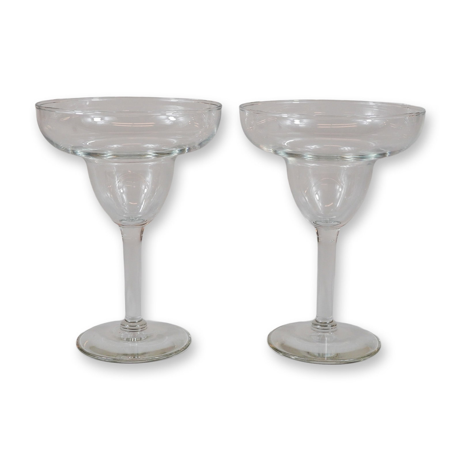 2pc Clear Glass Margarita Glasses: This set of two clear glass margarita glasses features a classic double-bowl design, characterized by a wide and shallow upper rim that tapers into a smaller, rounded lower bowl. Each vessel is