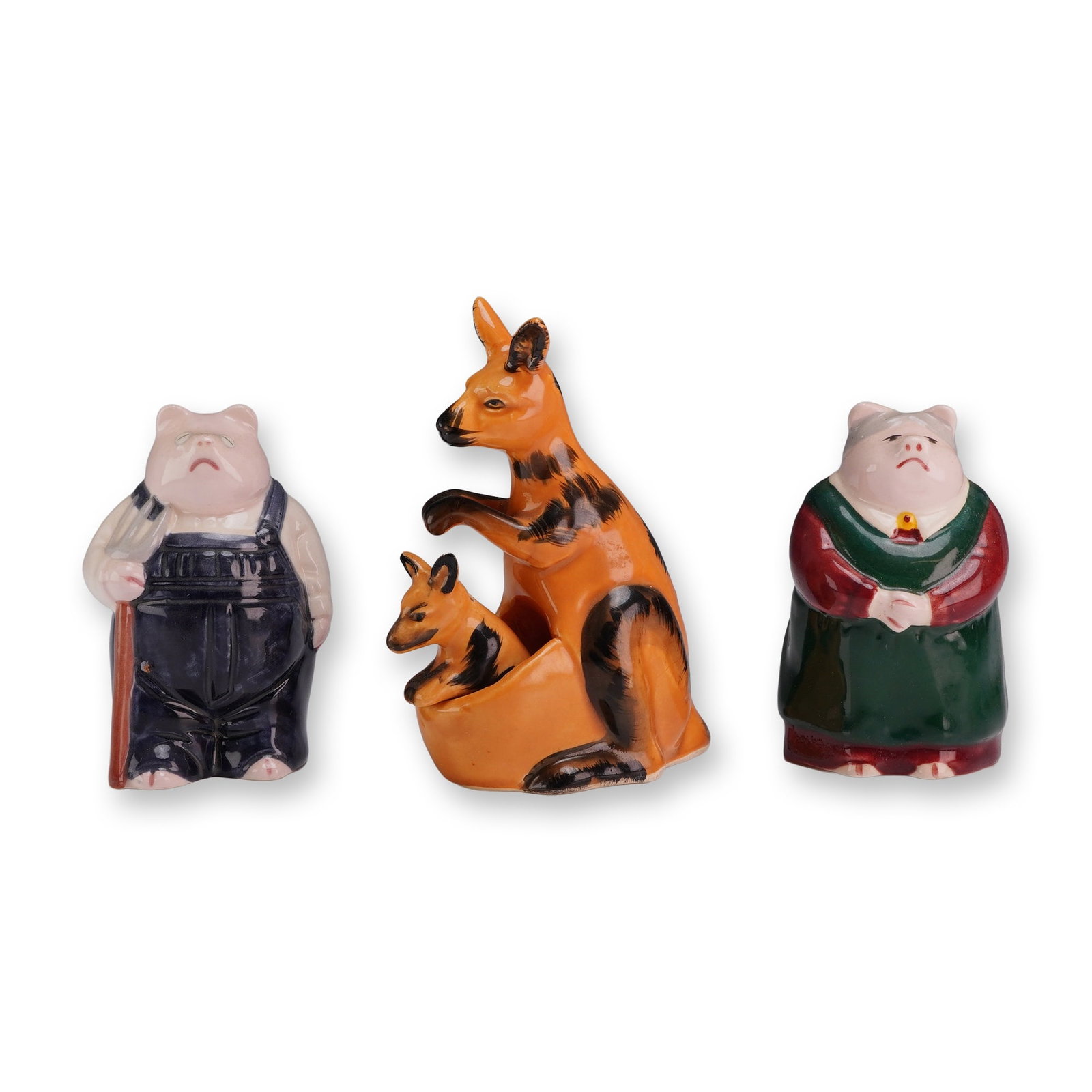 Two Pairs of Ceramic Animal Salt and Pepper Shakers: Two pairs of salt and pepper shakers in glazed ceramic, featuring anthropomorphic pigs and kangaroos. The pig pair is modeled in a rustic style reminiscent of American Gothic, featuring a farmer in da