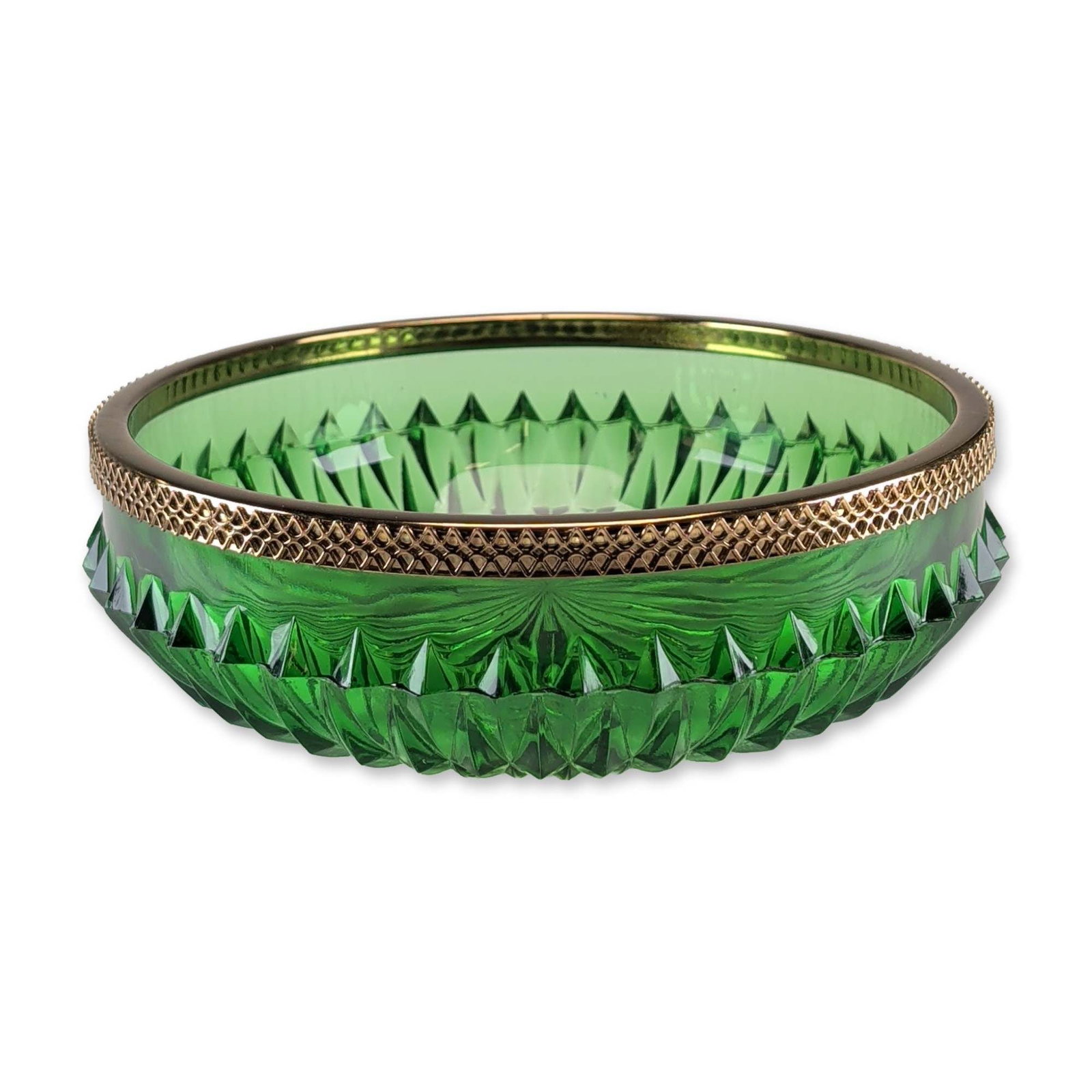 Emerald Green Cut Glass Metal Mounted Bowl: An emerald-green glass bowl featuring deep vertical wedge-cut facets and a large radiating starburst pattern to the base. The piece is finished with a gold-tone metal-mounted rim decorated in a